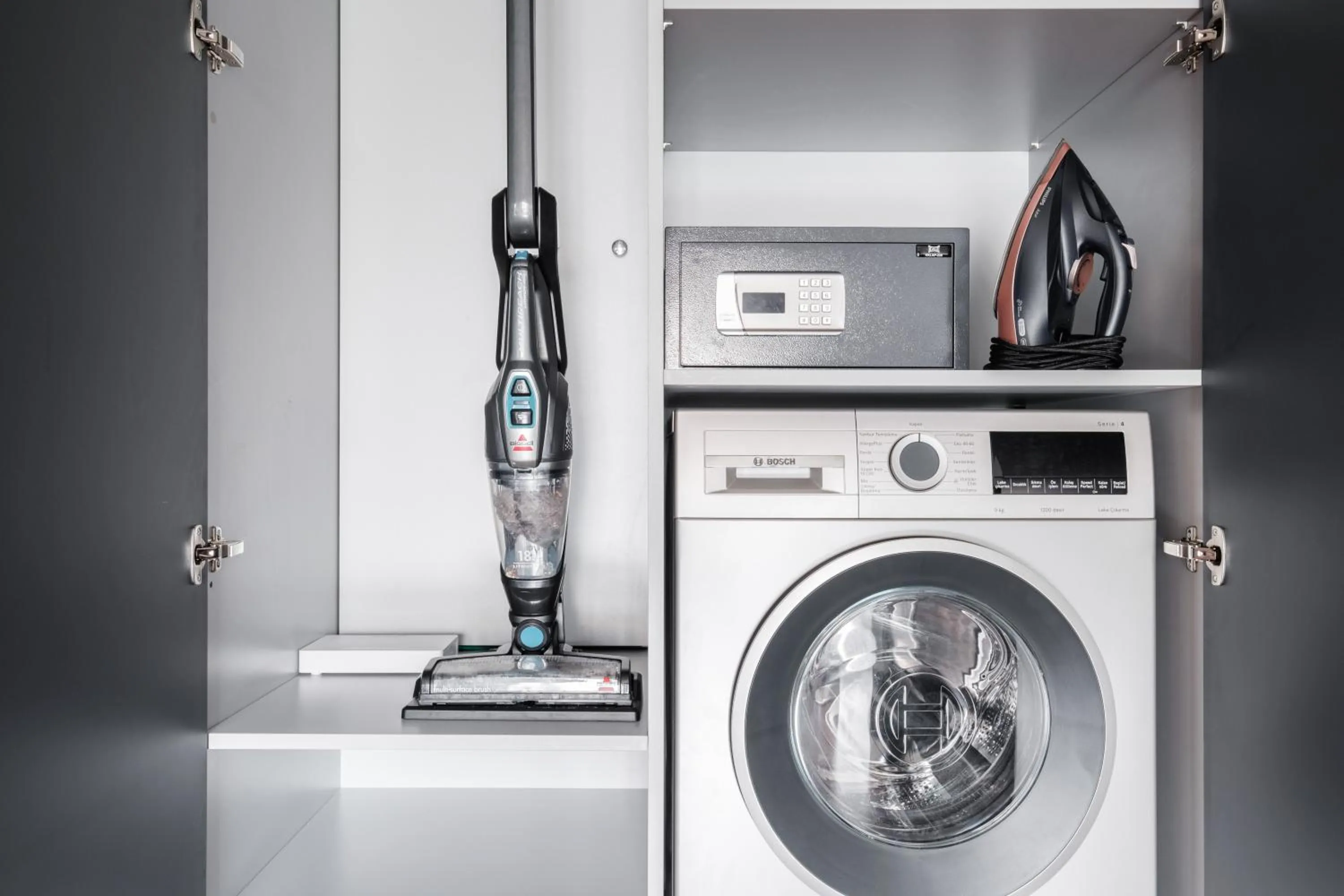 washing machine in Benesta Residence by NewInn