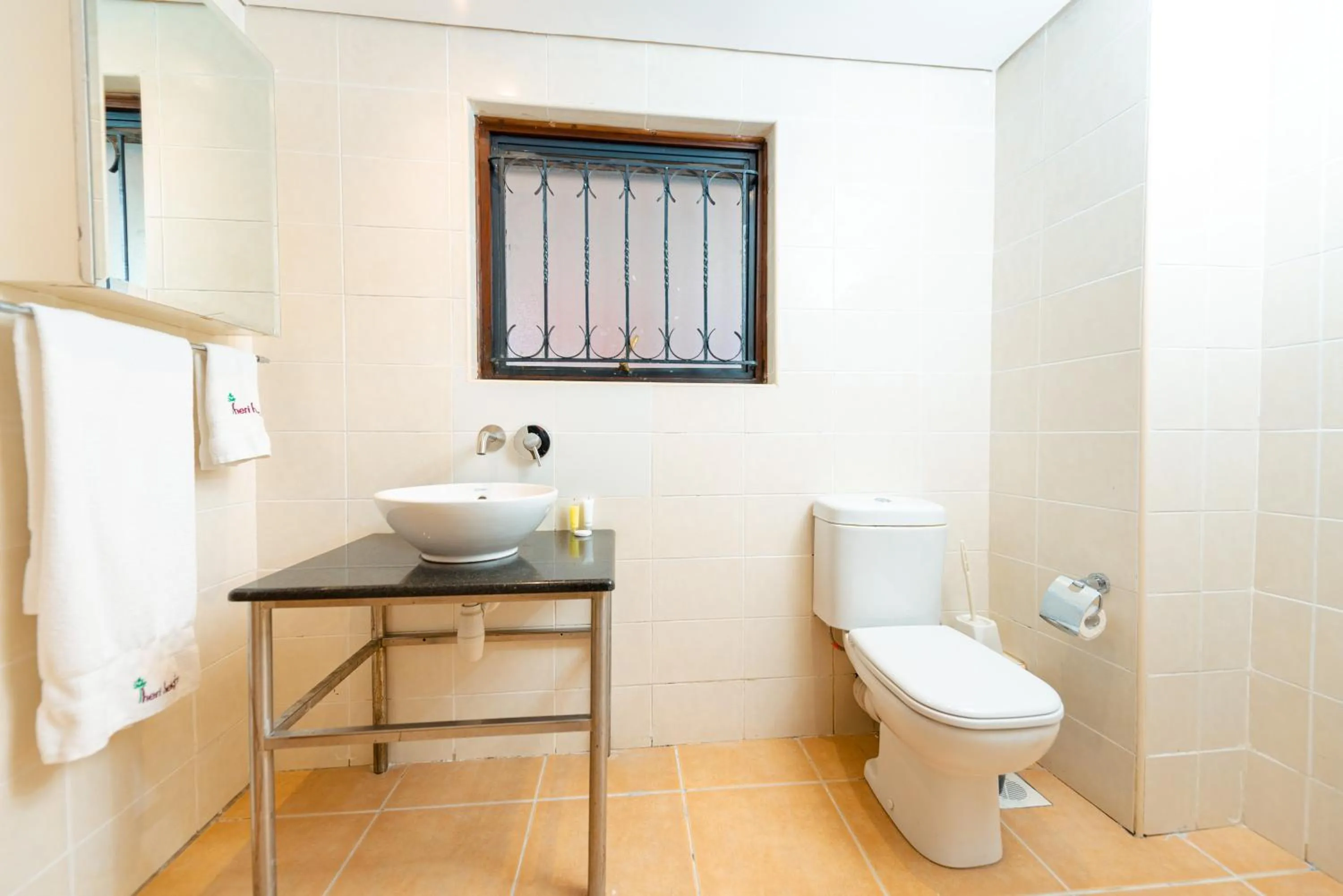Toilet in Heri Heights Hotel Apartments, SureStay Collection by Best Western