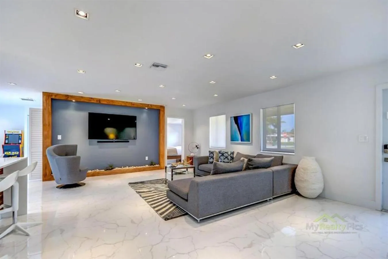 Communal lounge/ TV room in Magical Miami Retreat with Heated Pool, Mini Golf, and Basketball Court L19