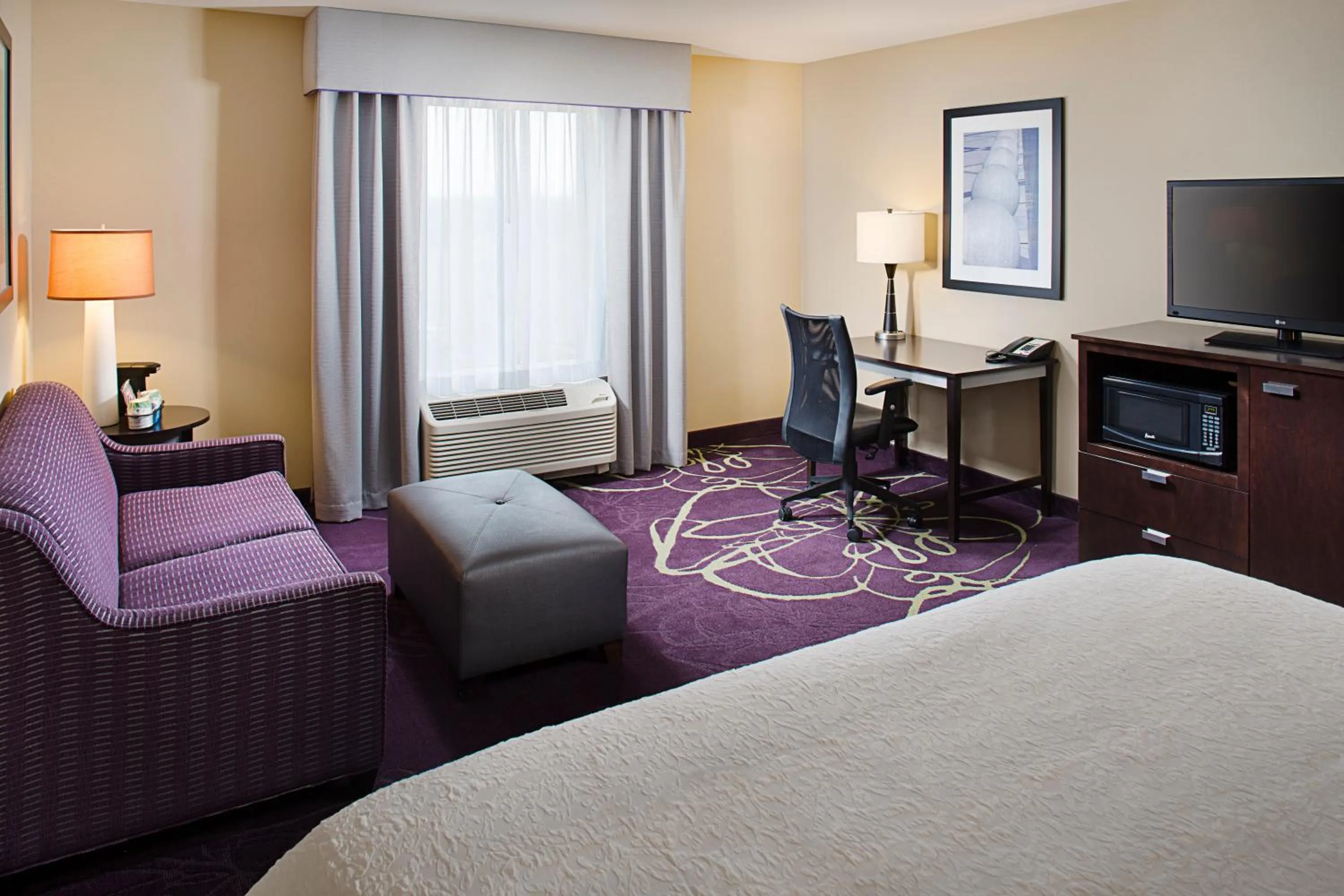 Seating area, Bed in Hampton by Hilton Lansing West