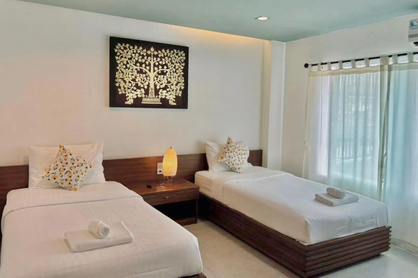 Bed in De Nawarat Chiangmai Boutique Apartment