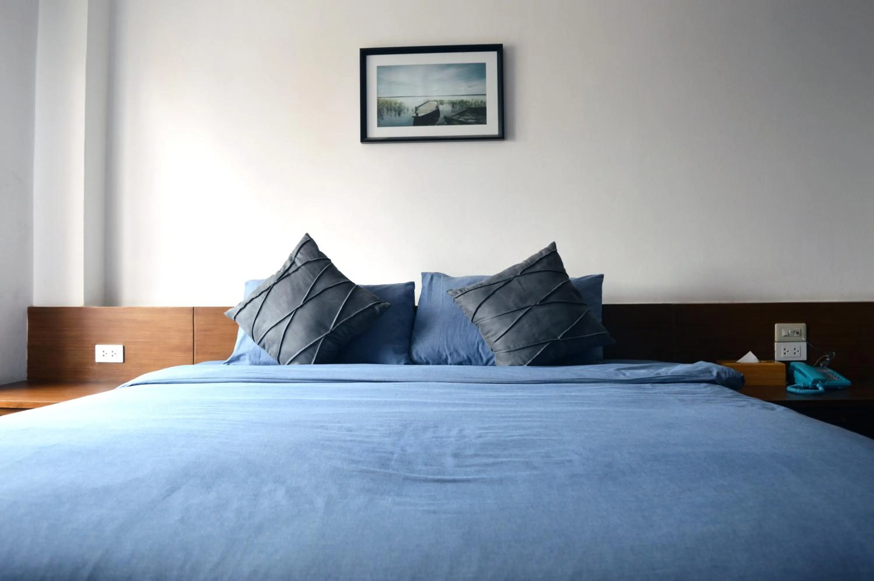 Bed in De Nawarat Chiangmai Boutique Apartment