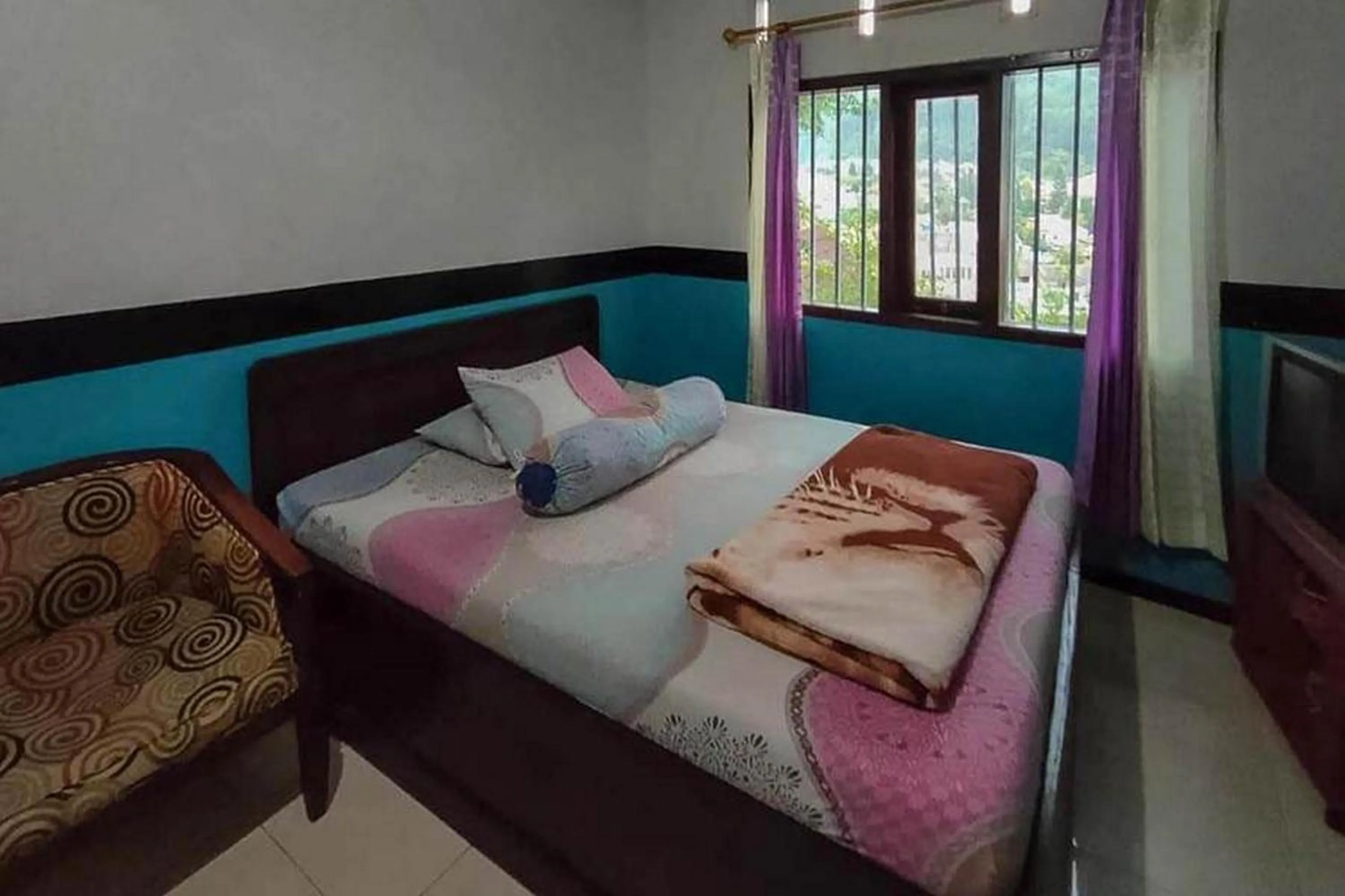 Bed in Villa Ghazani 4 at Desa Wisata Songgokerto