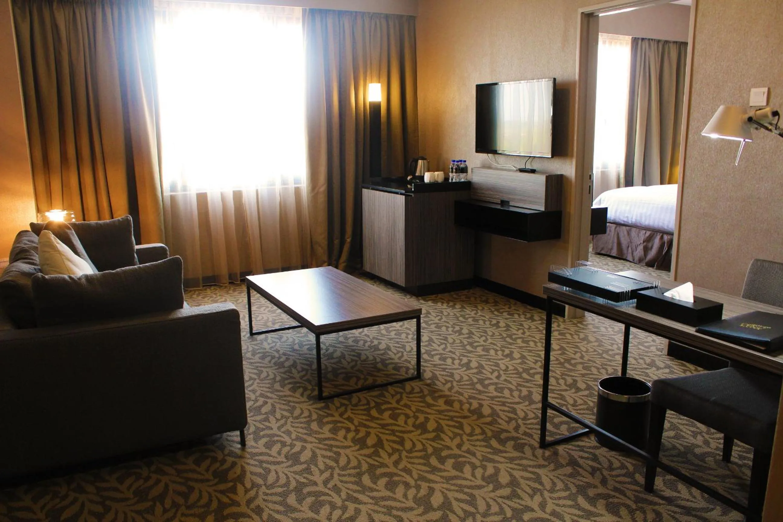 Seating area, Bed in Grand Alora Hotel