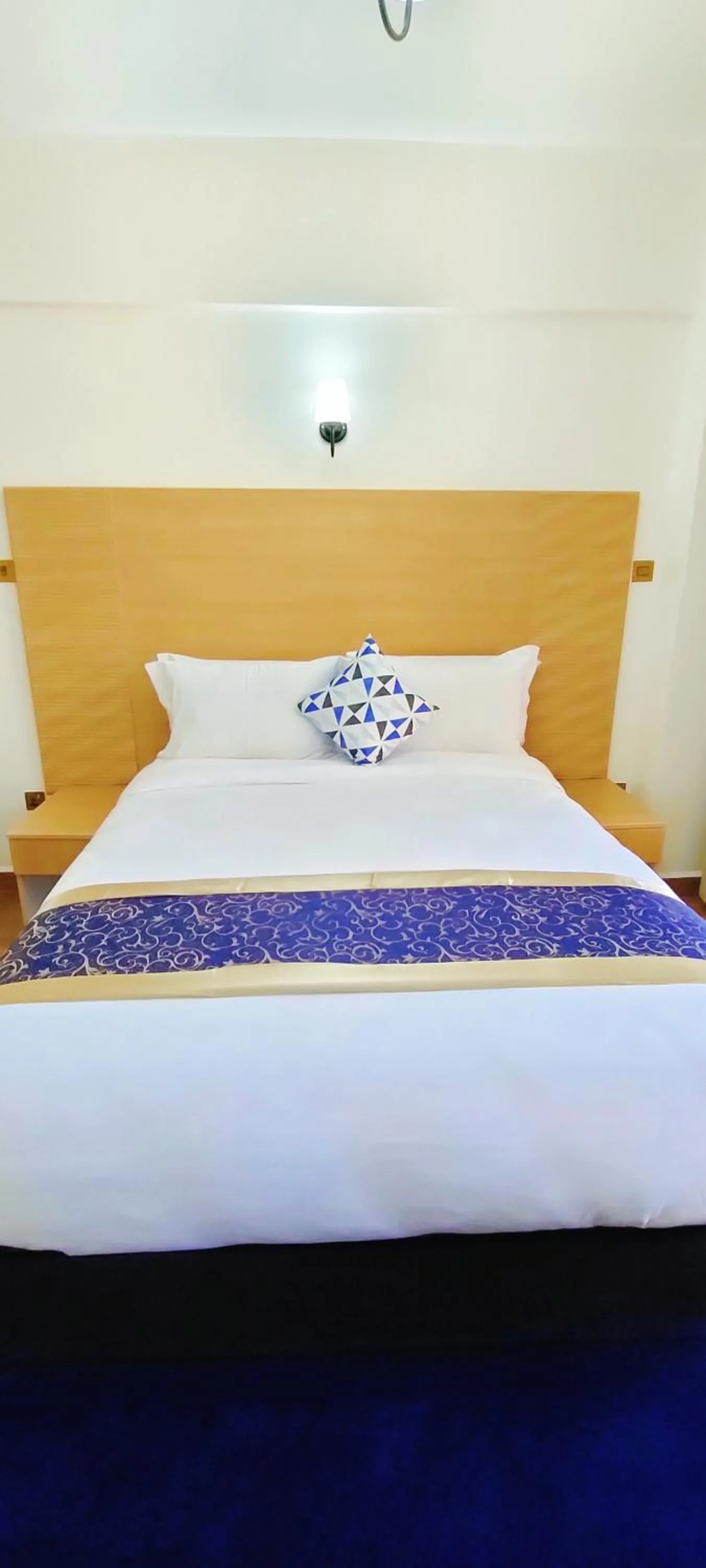 Bed in Hays Suites Hotel