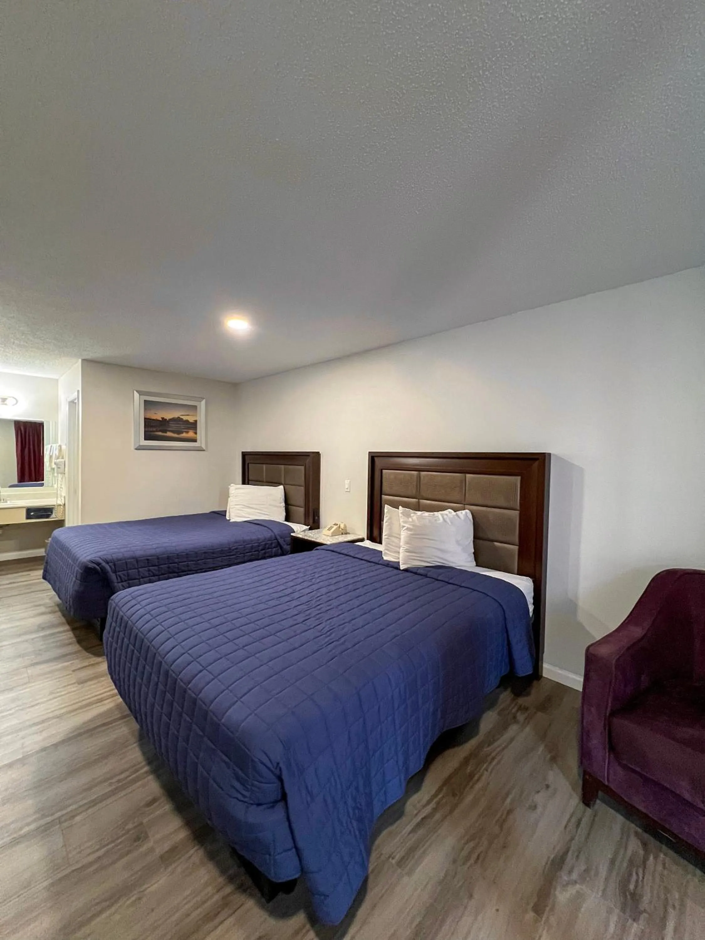 Bed in Garden Inn & Suites