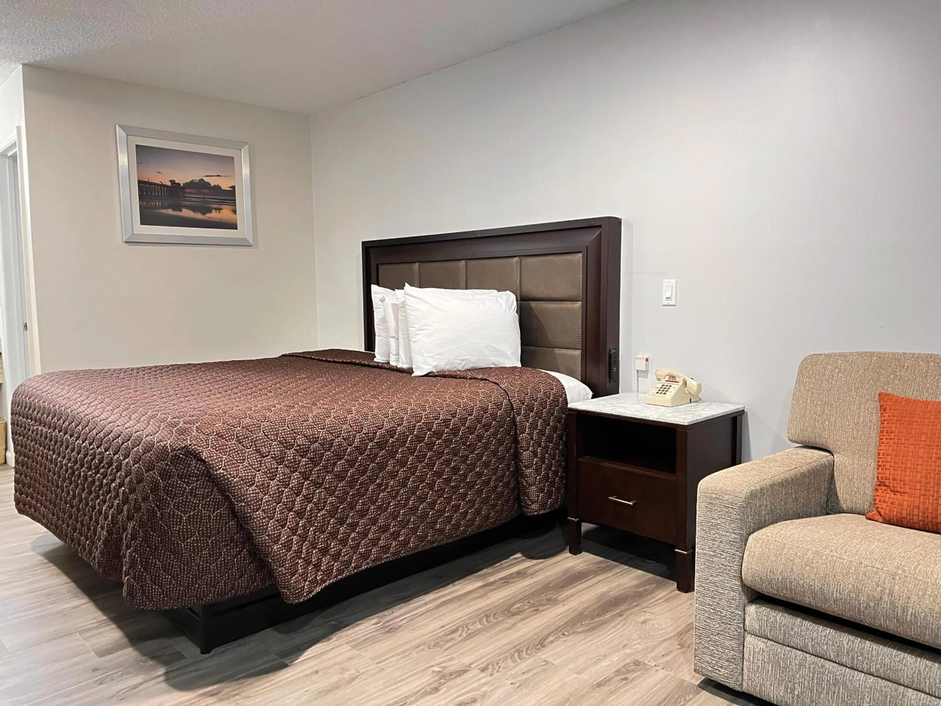 Bed in Garden Inn & Suites