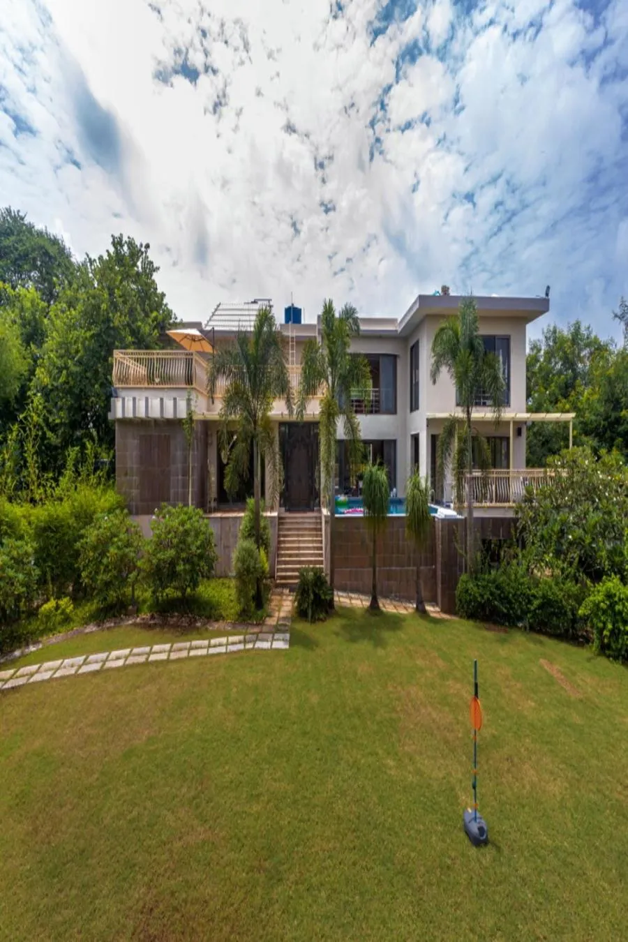 Property building in SaffronStays Aura - 4BR luxury pool villa with gym, BBQ deck, lawns & indoor games near Kihim Beach