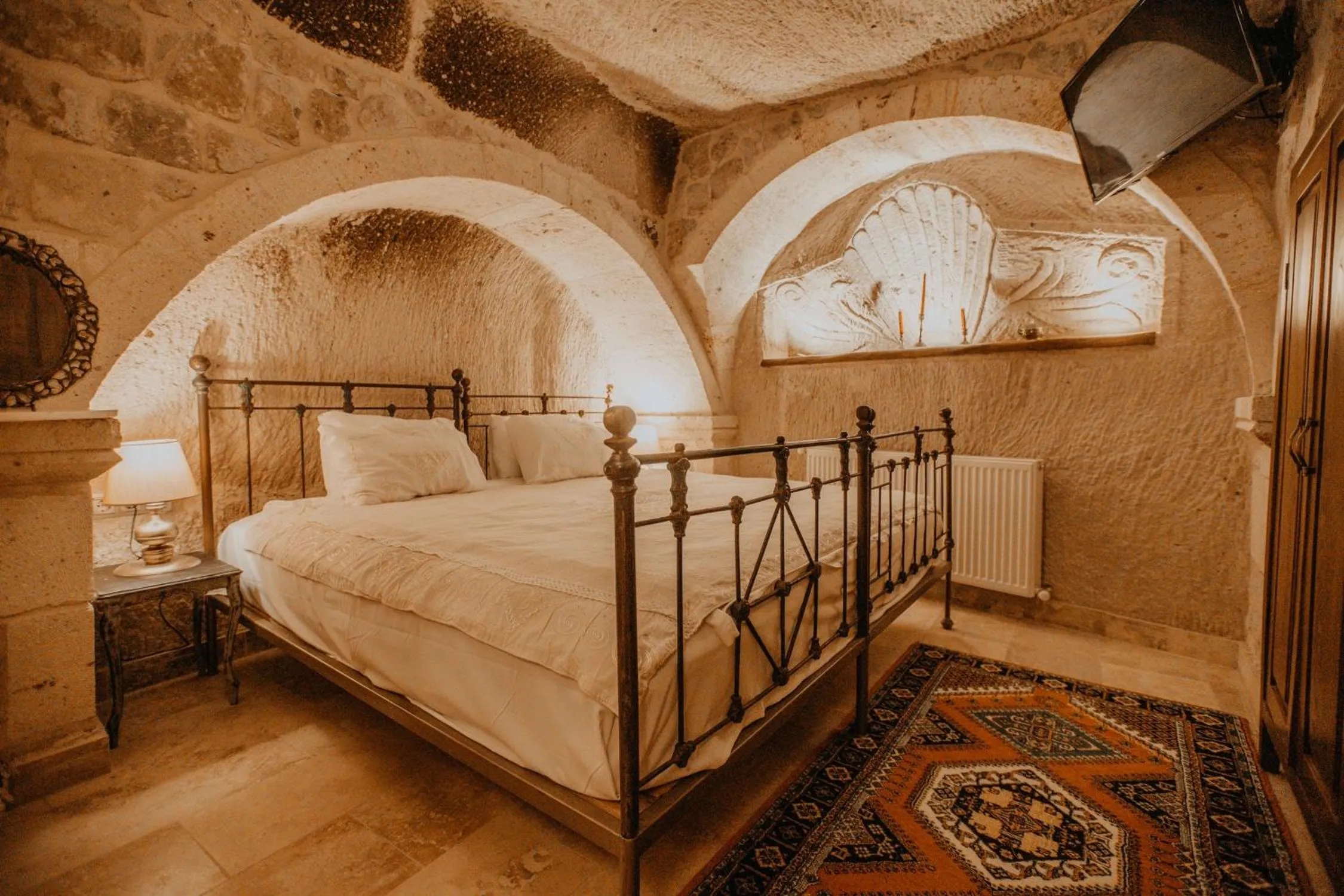 Bed in Serenus Cave Suites