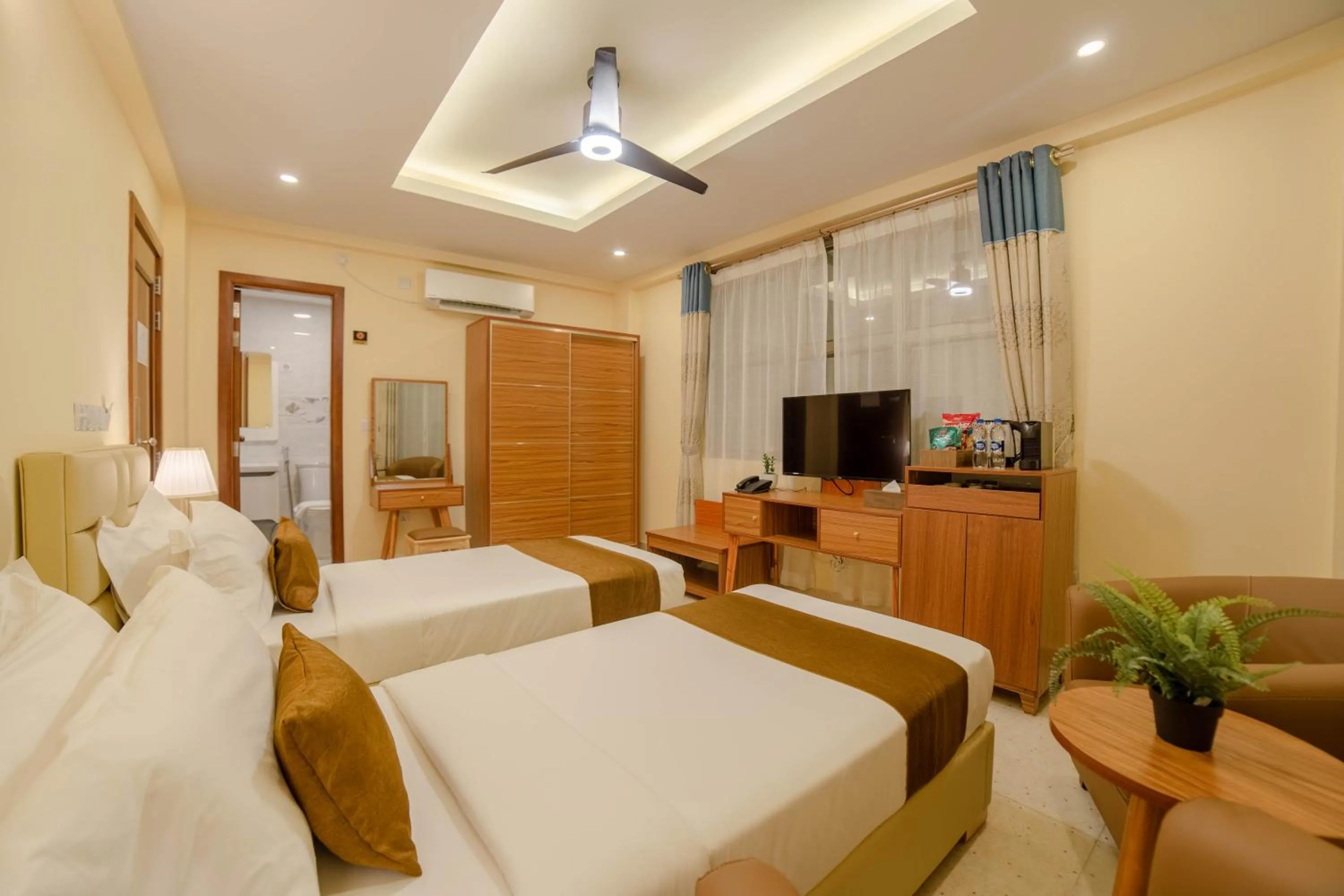 Communal lounge/ TV room, Bed in Amber Beach Hotel at Hulhumale