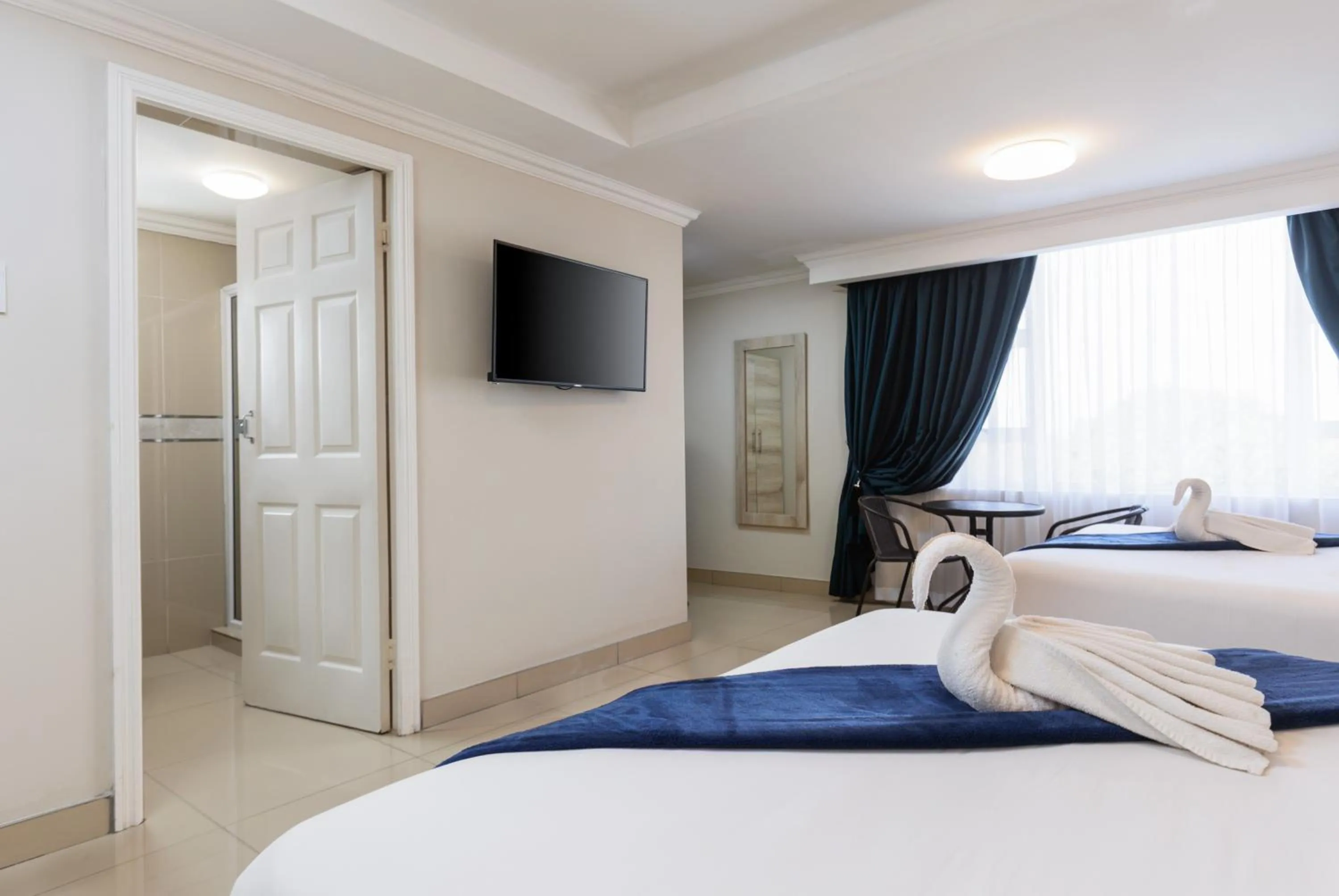 Bed in Bayside Taj Hotel