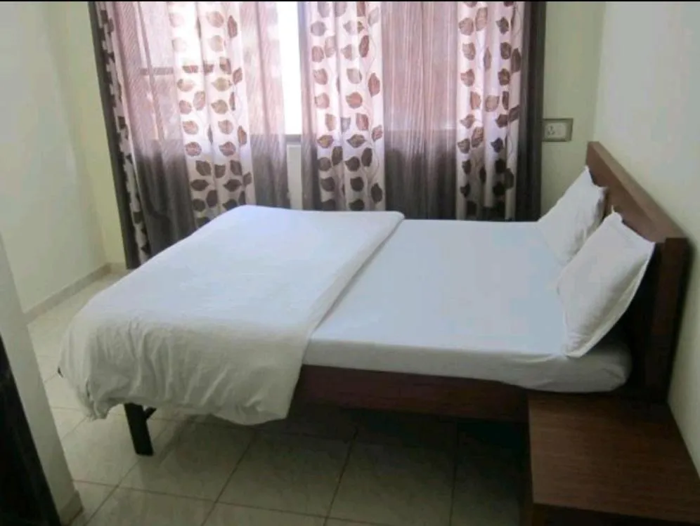 Bed in Hotel Dhruv Palace