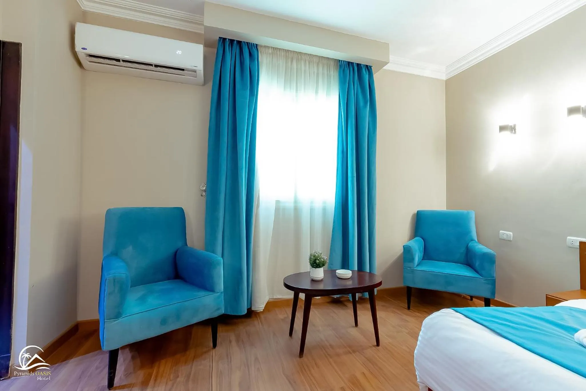 Seating area, Bed in Pyramids Oasis Hotel