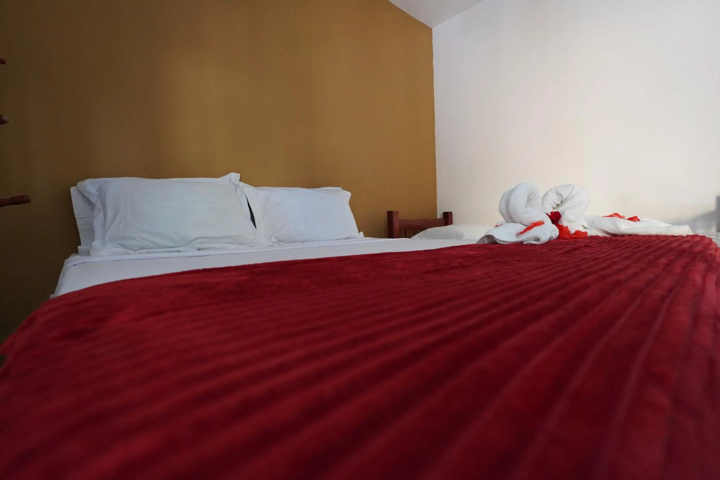 Bed in Pousada Frezza Mergulho