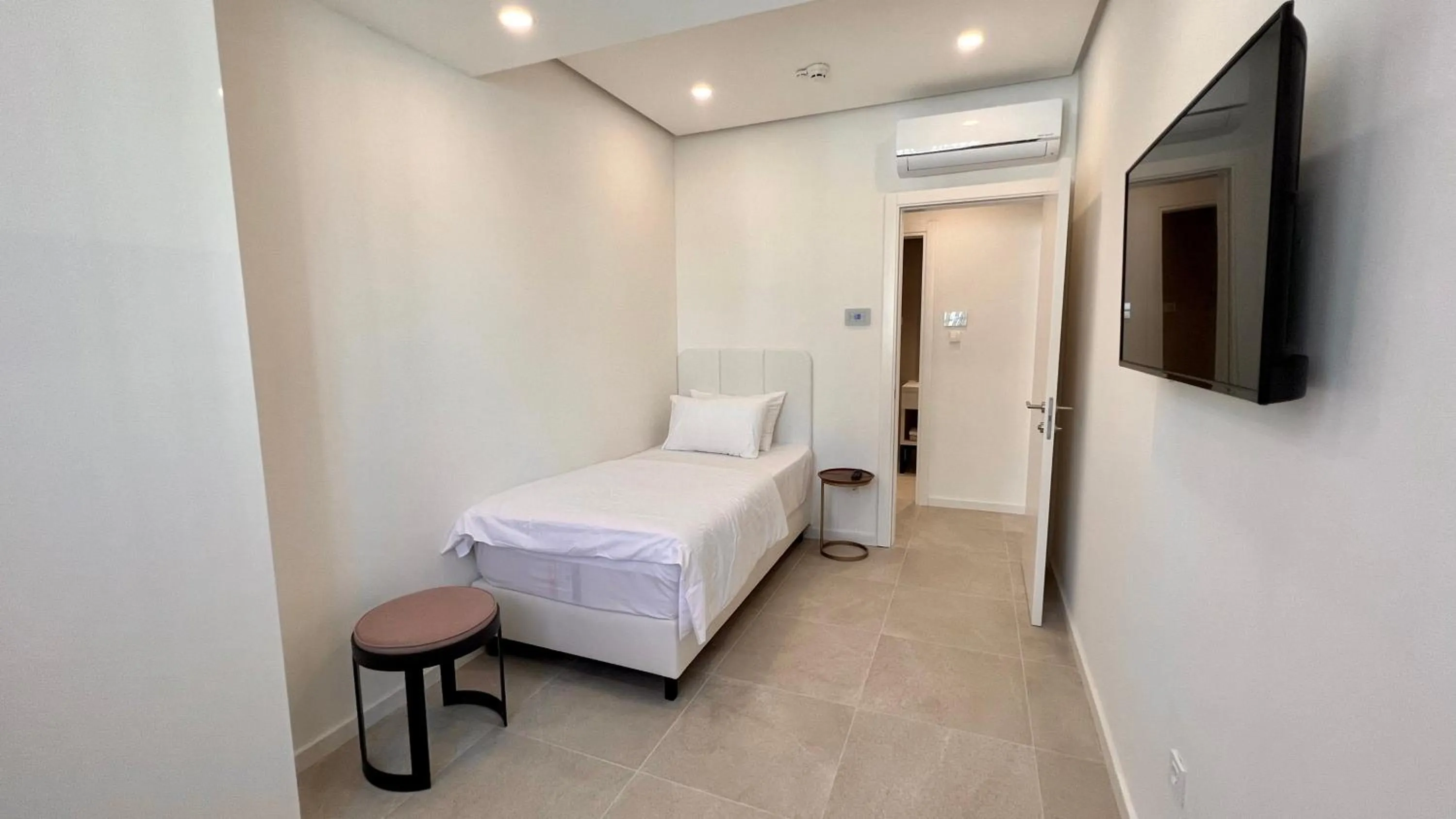 Bed in Sunraf Luxe Apartments