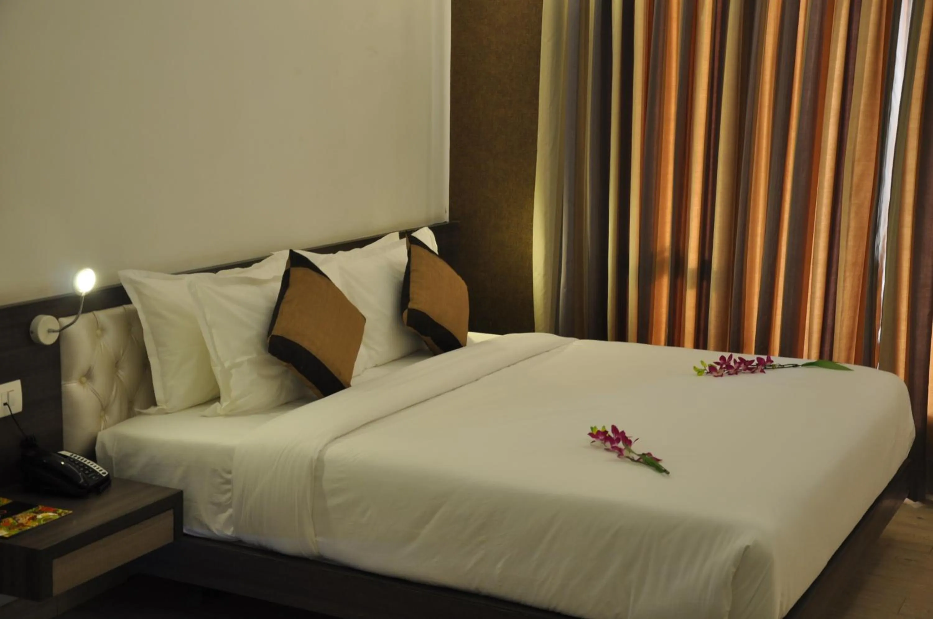 room service, Bed in Pride Biznotel Alkapuri Near Vadodara Airport