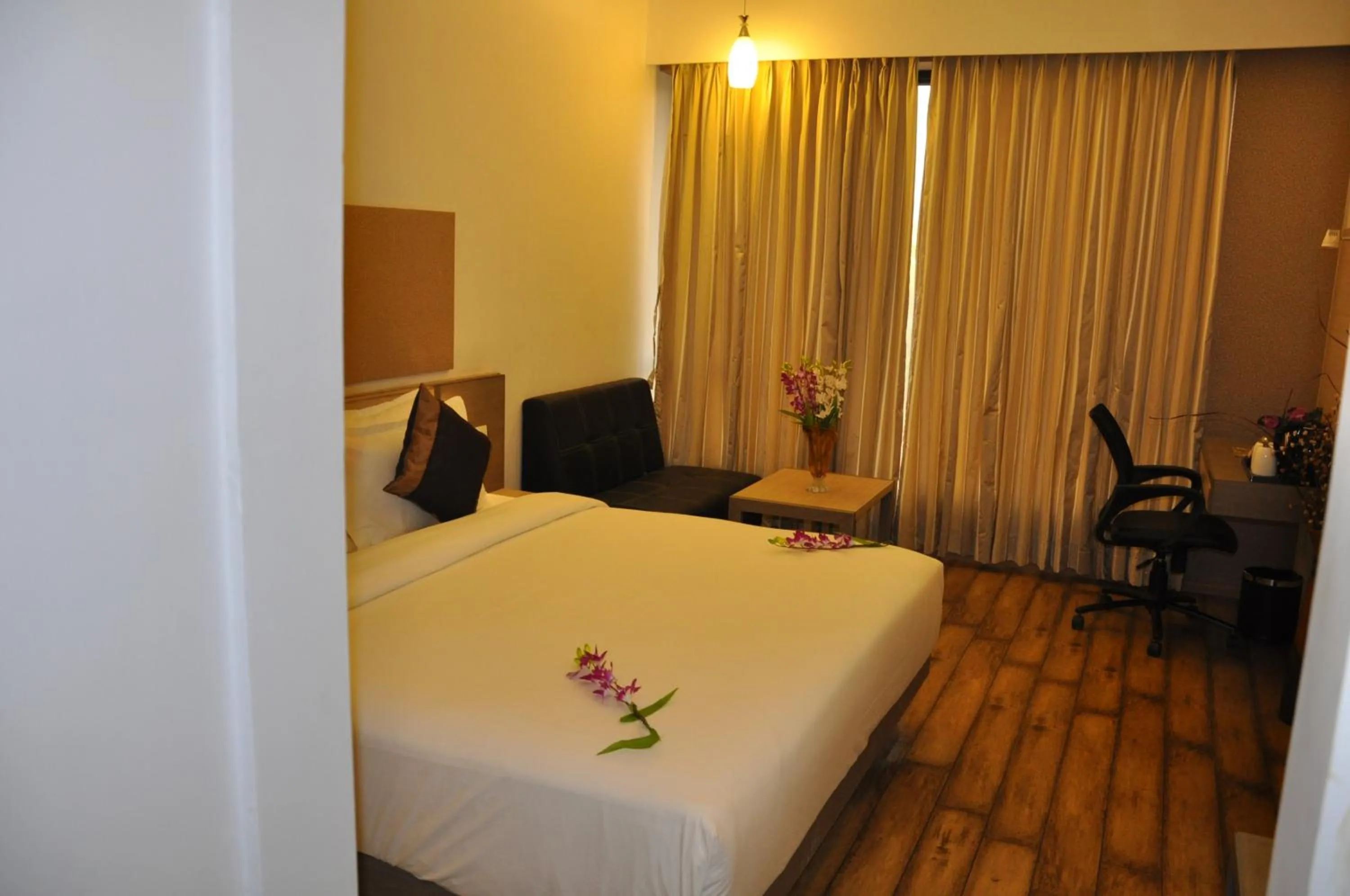 Photo of the whole room, Bed in Pride Biznotel Manjusar Vadodara Near Sokhda Lake