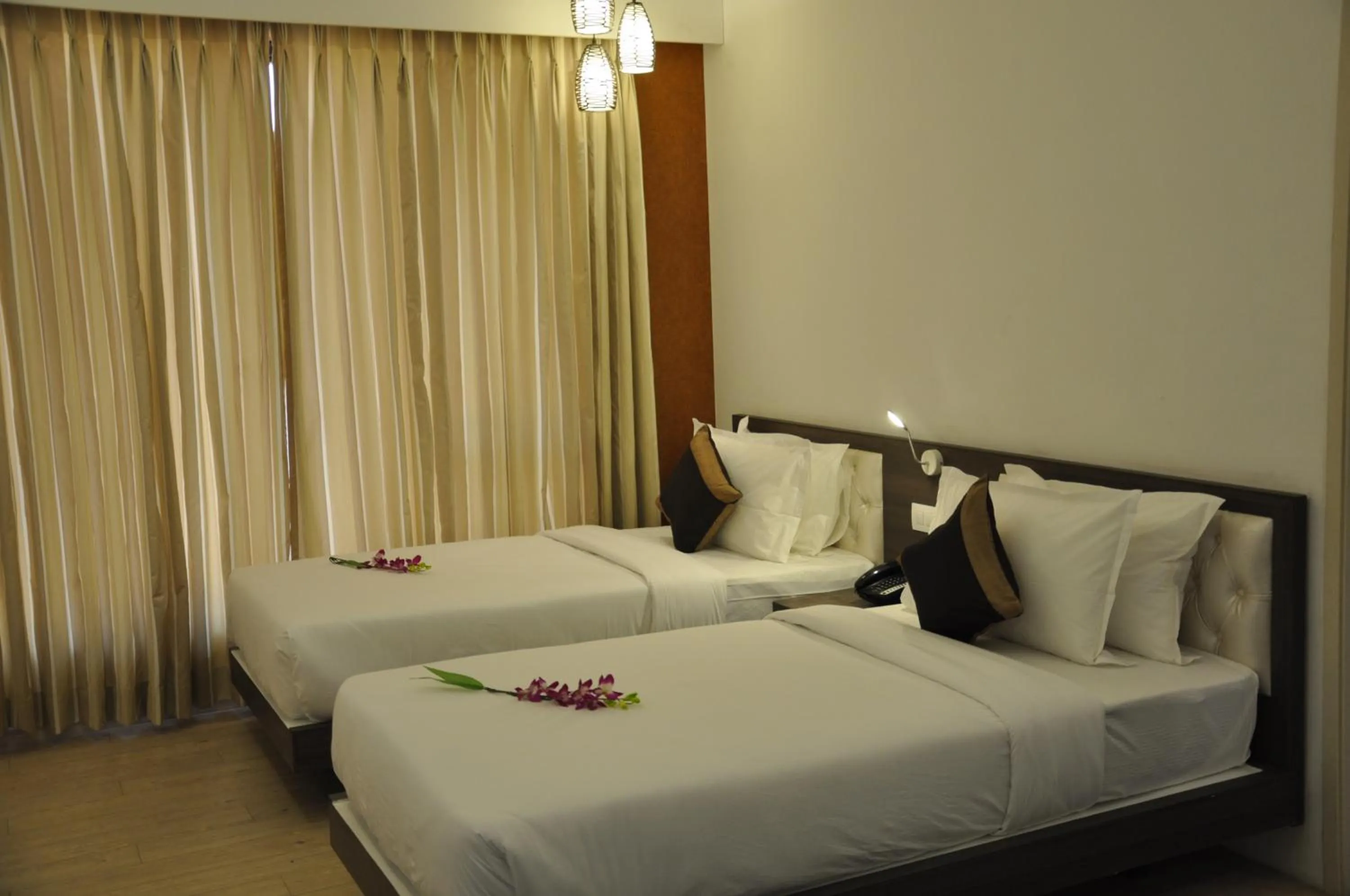 Bed in Pride Biznotel Manjusar Vadodara Near Sokhda Lake