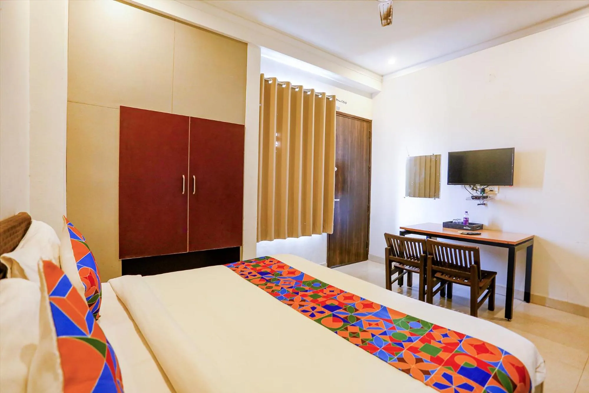 Communal lounge/ TV room, Bed in FabExpress Novel Suites - Nr Yashobhoomi Convention Centre