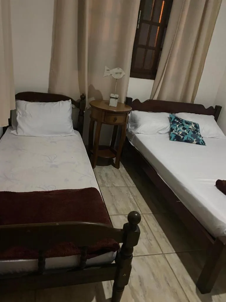 Bed in Pousada Casa de mãe aconchegante com piscina próximo à praia