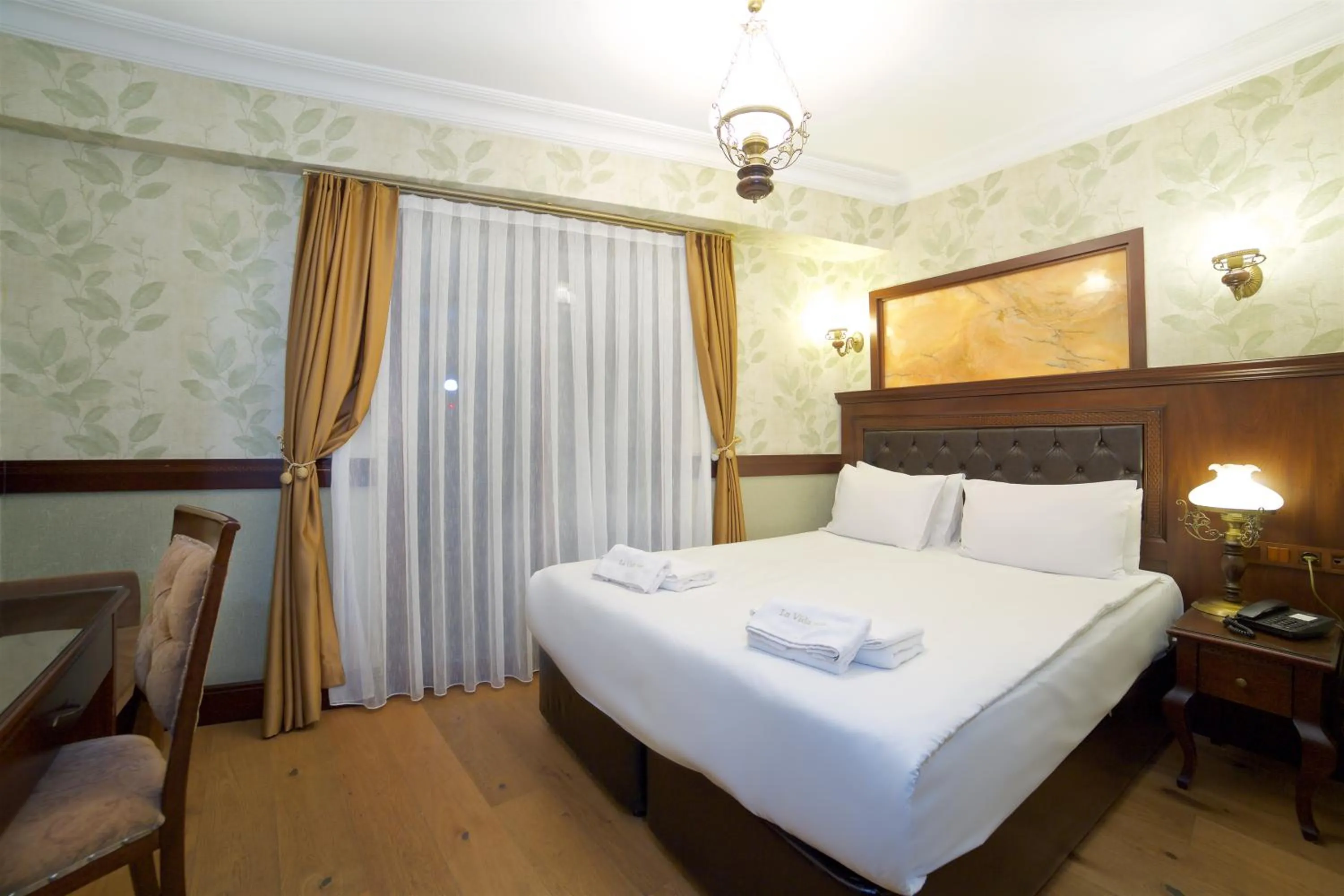 Bed in La Vida Old City Hotel