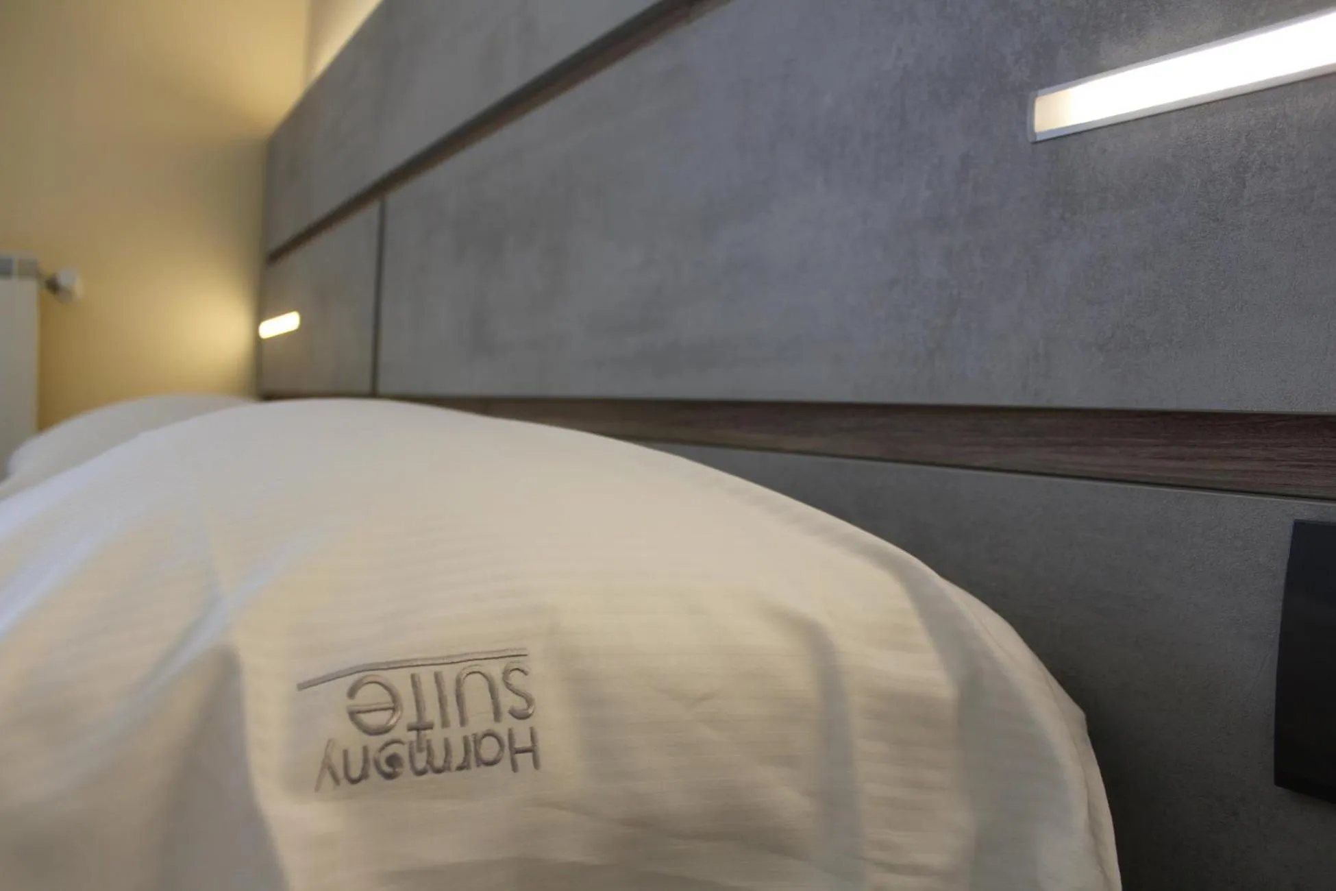 Bed in Harmony Suite Hotel