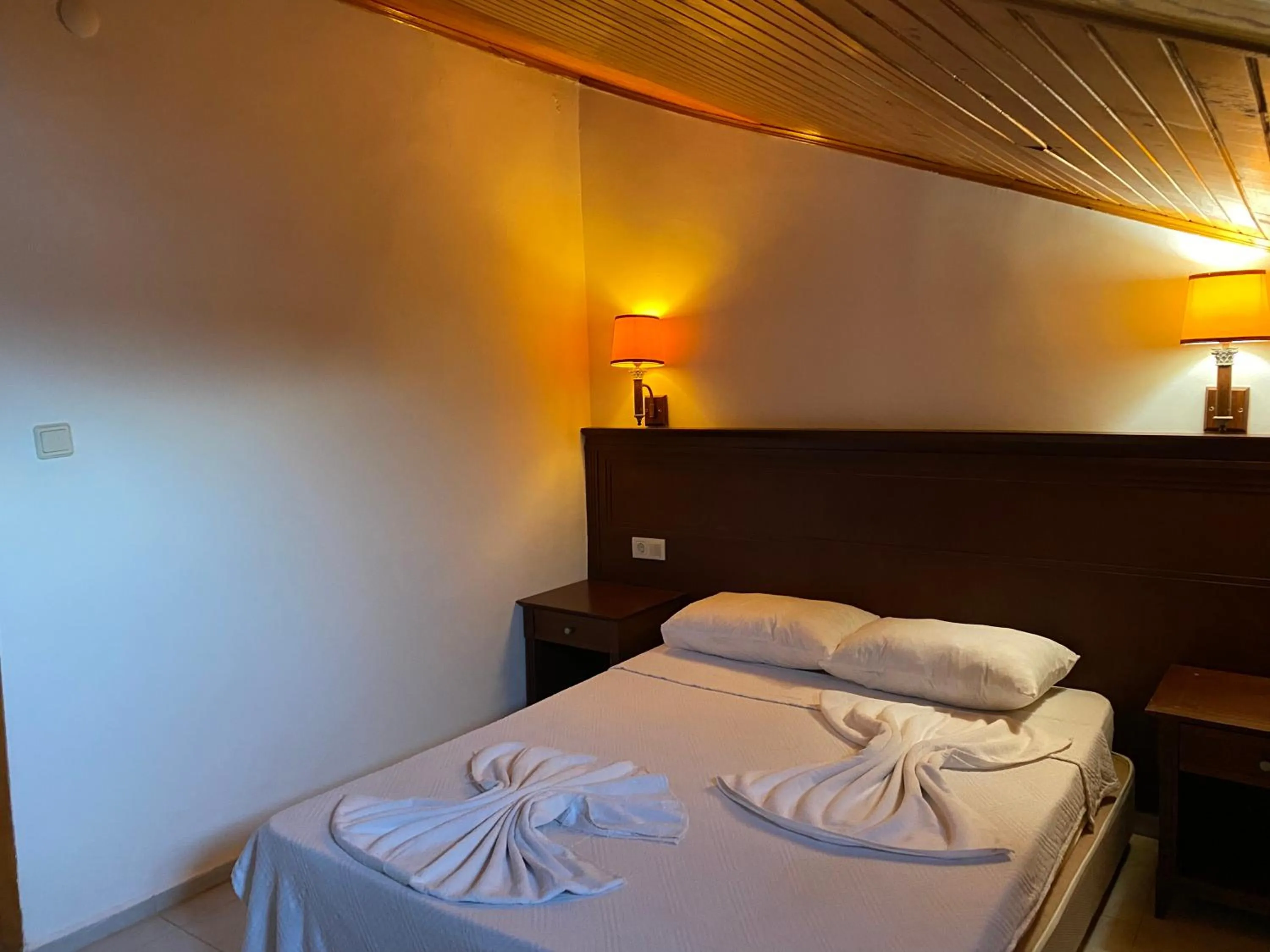 Bed in NATURELLA APART HOTEL