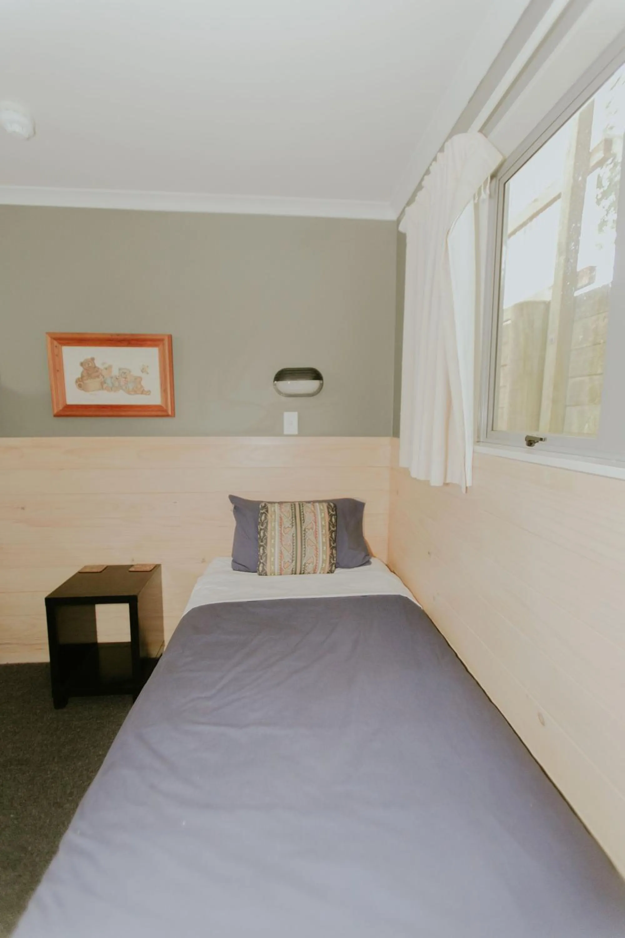 Bed in Waitomo Village Chalets home of Kiwipaka