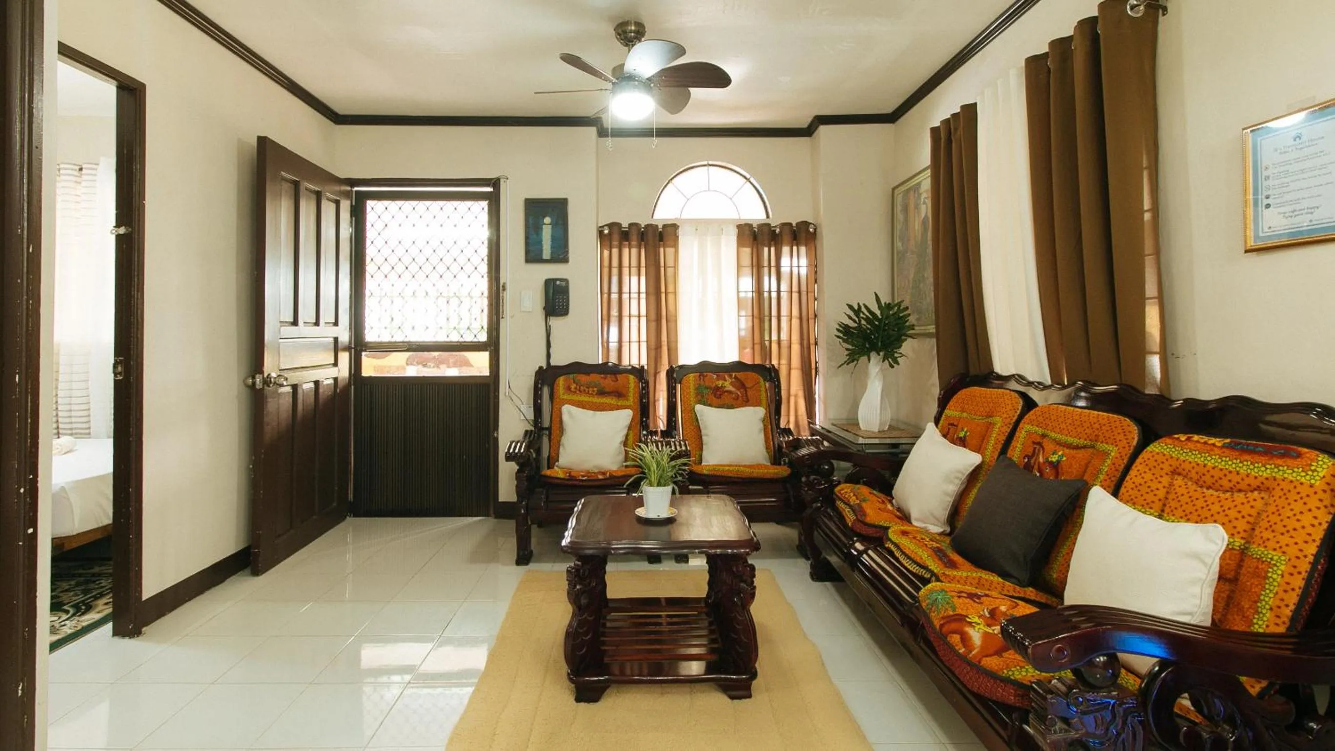 Seating area, Bed in Jb's Transient House