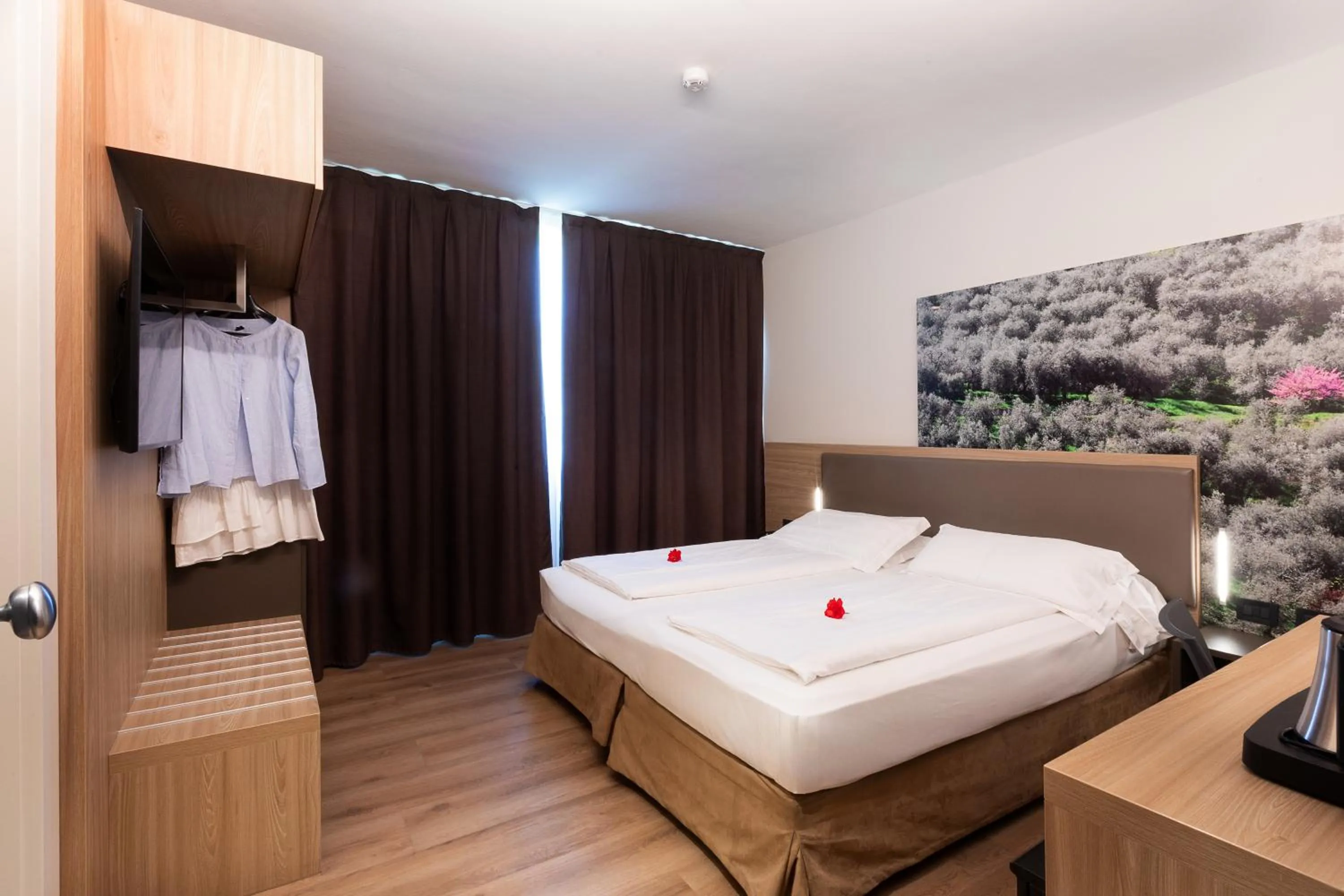 Bed in Ambassador Suite Hotel