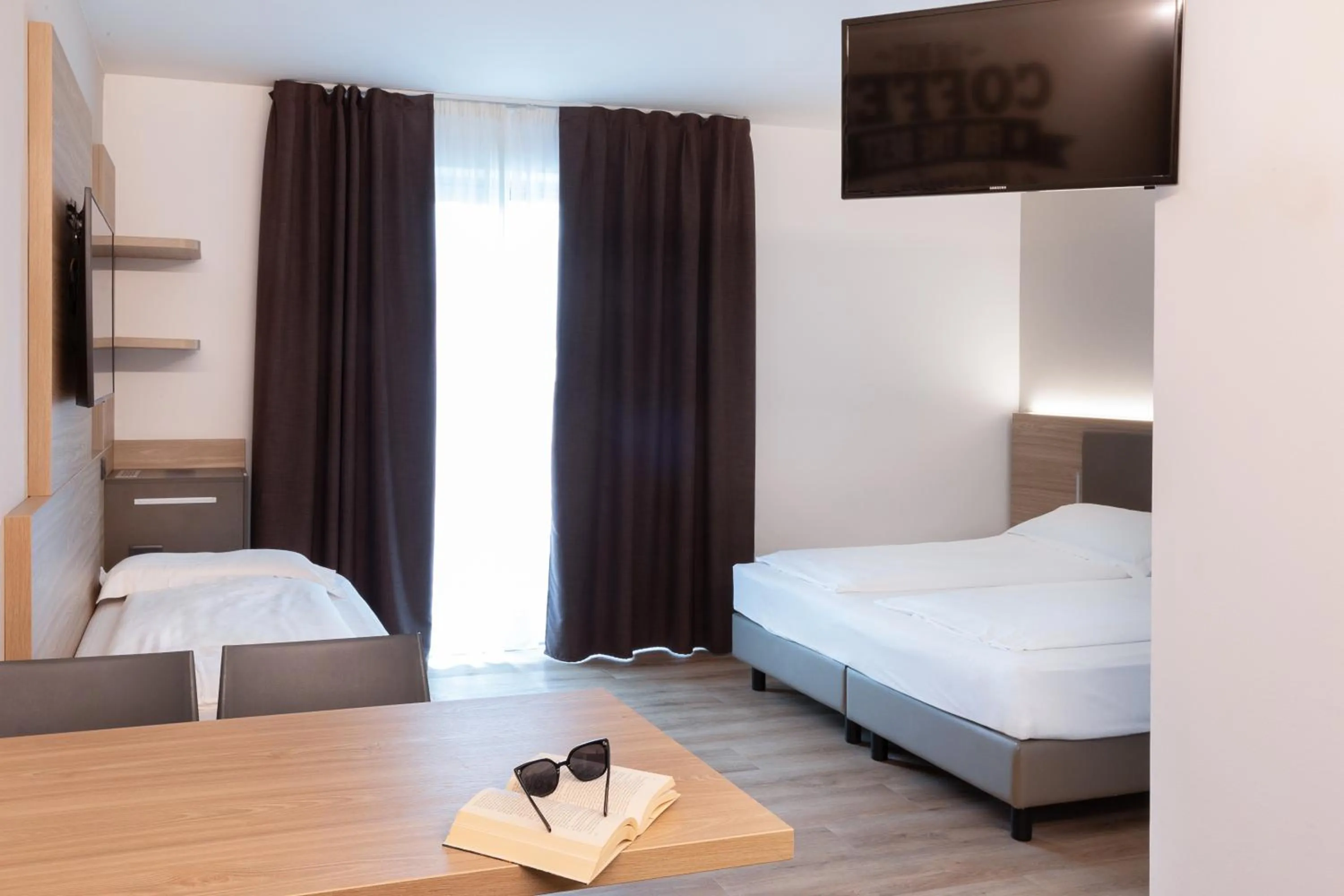 Bed in Ambassador Suite Hotel