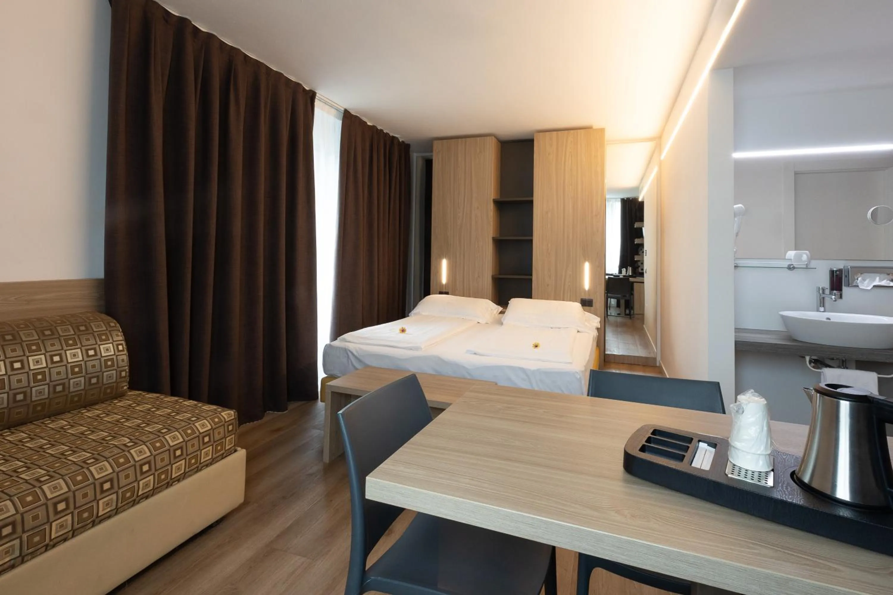 Bed in Ambassador Suite Hotel