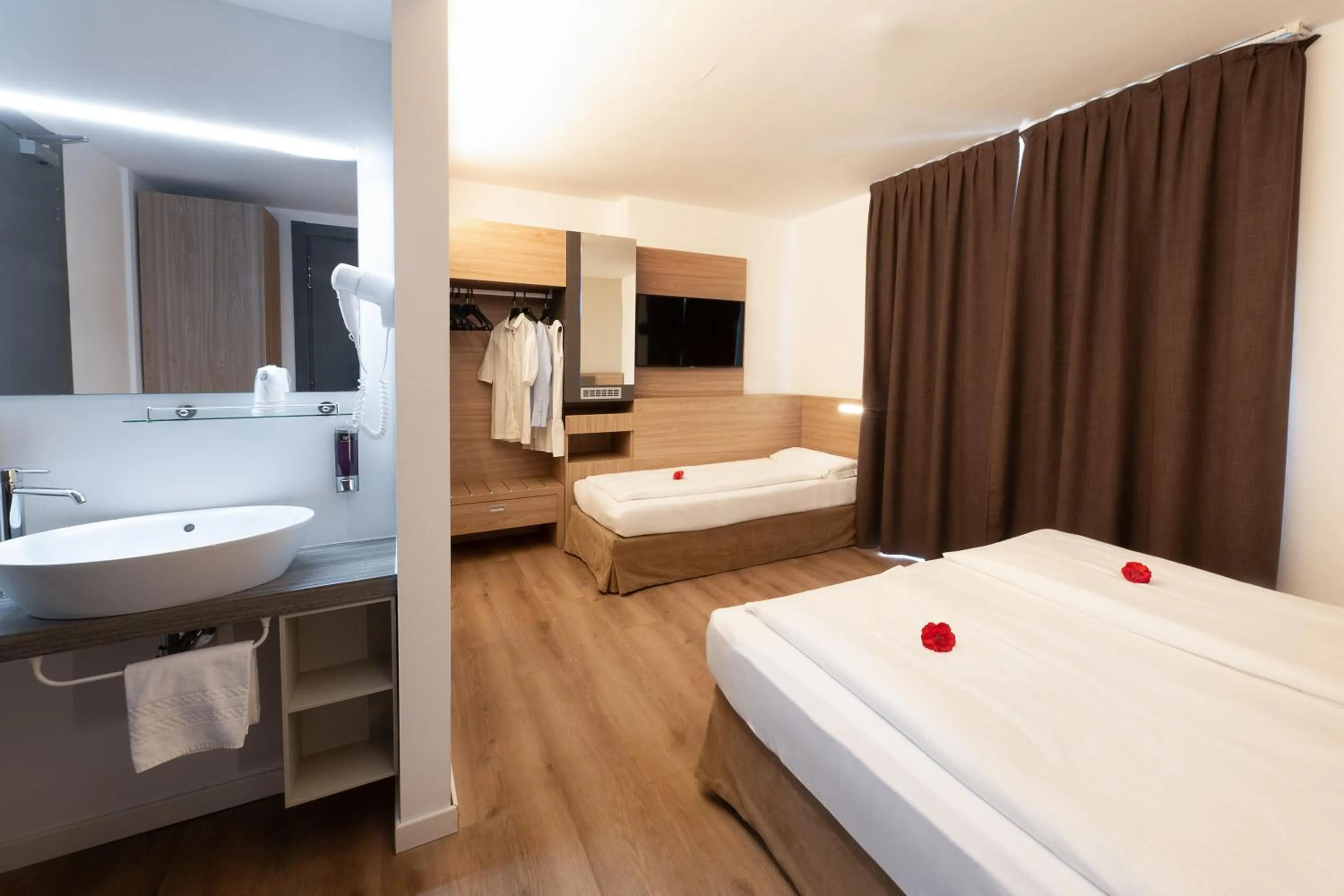 Bed in Ambassador Suite Hotel