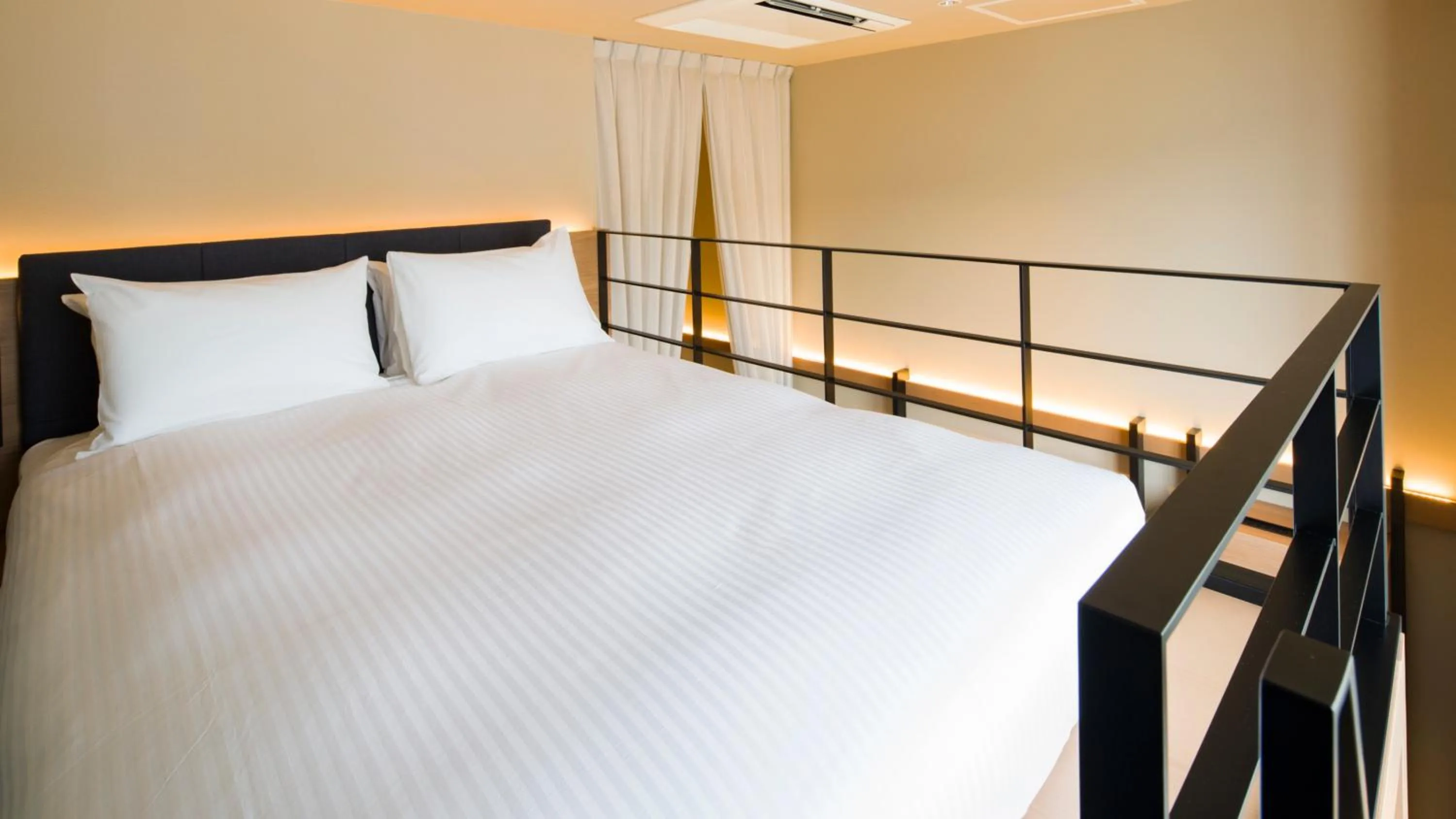 Bed in GRIDS PREMIUM HOTEL OTARU