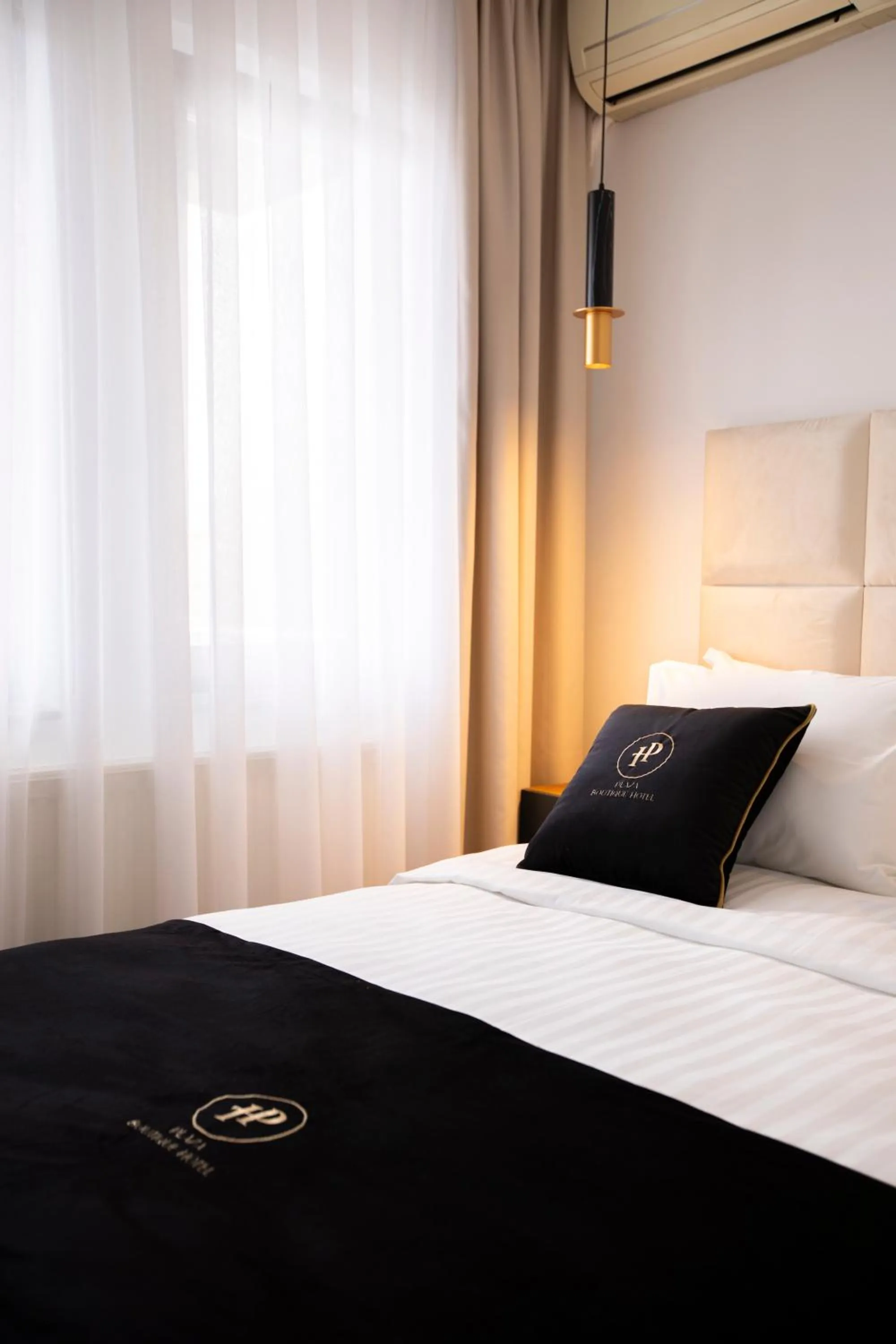 Bed in Plaza Boutique Hotel