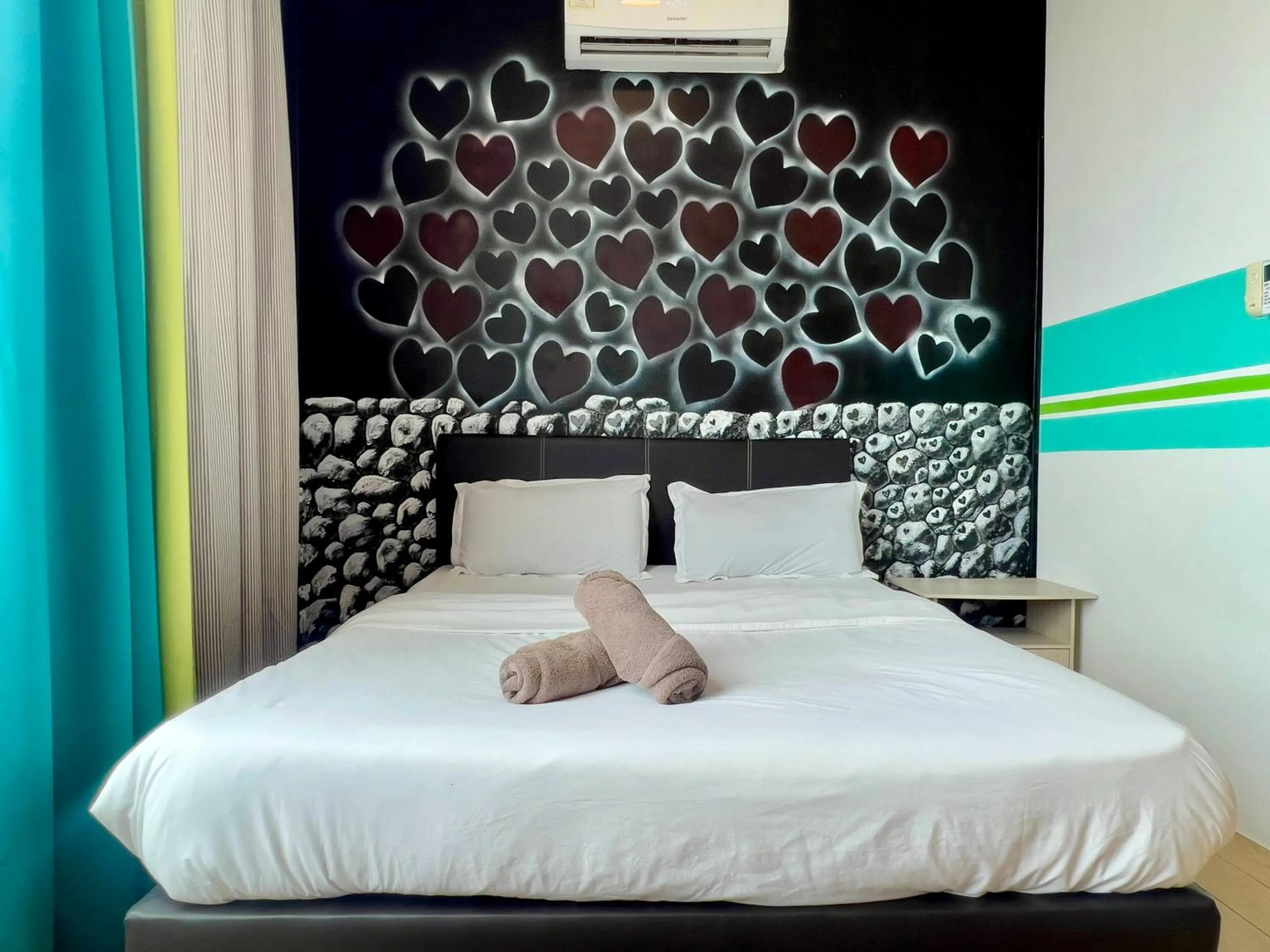 Bed in Hush Inn at ITCC Manhattan Suites