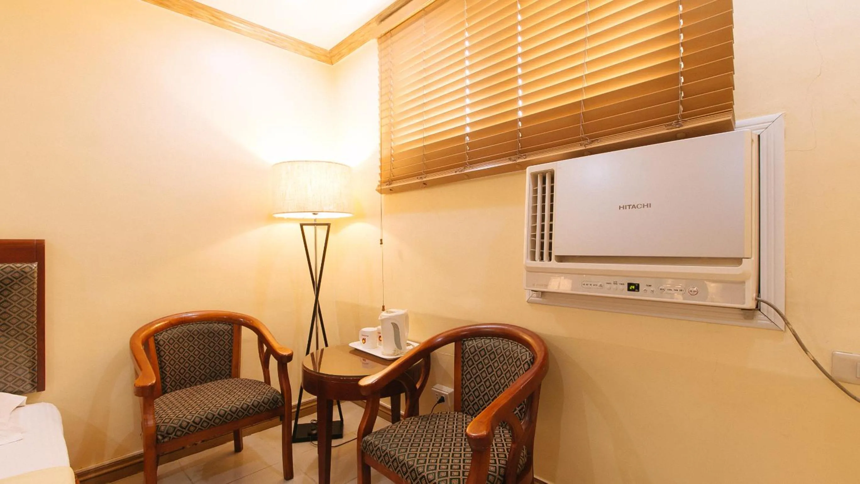 Seating area in Peace Hotel by RedDoorz