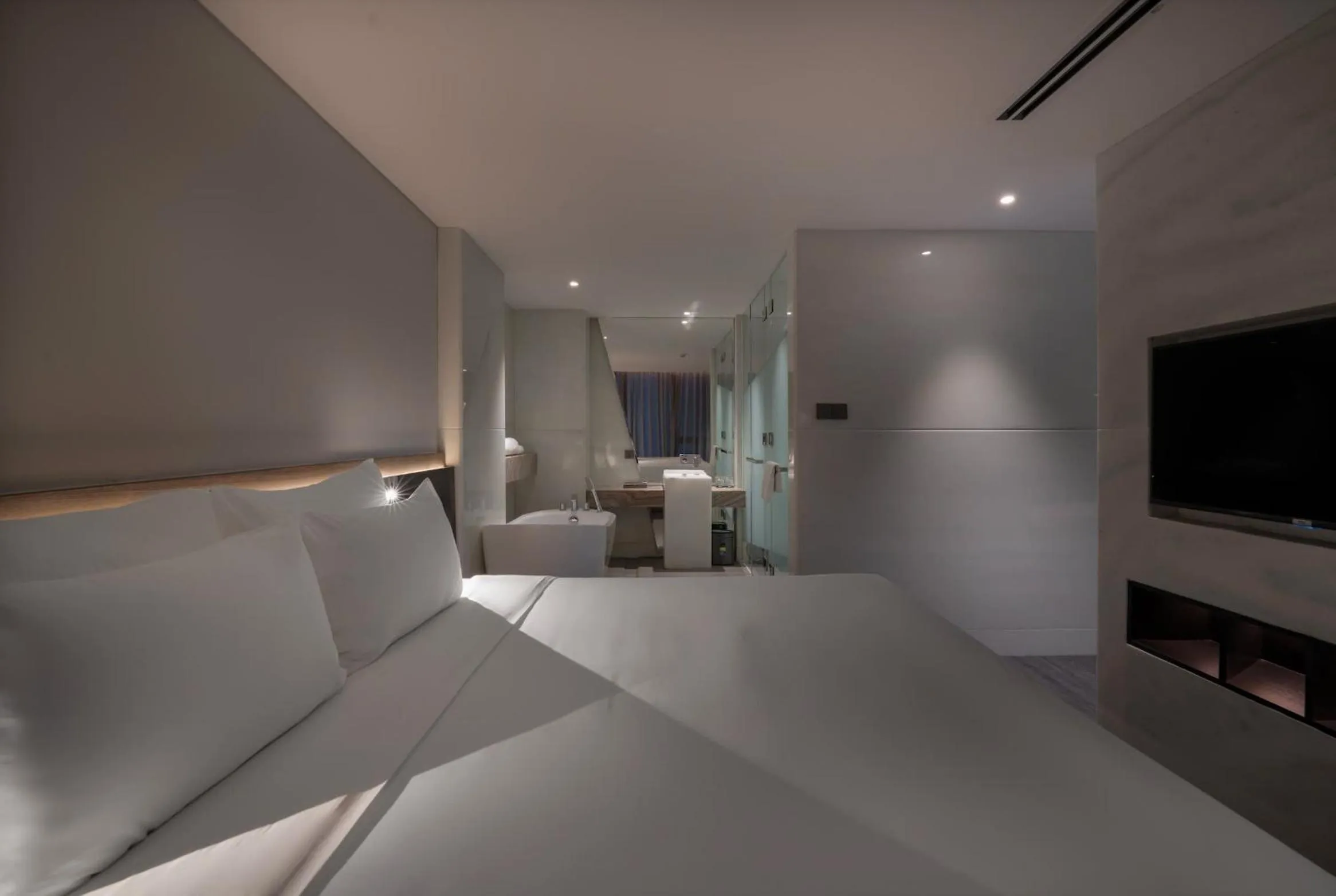 Bed in Draco Hotel & Suites