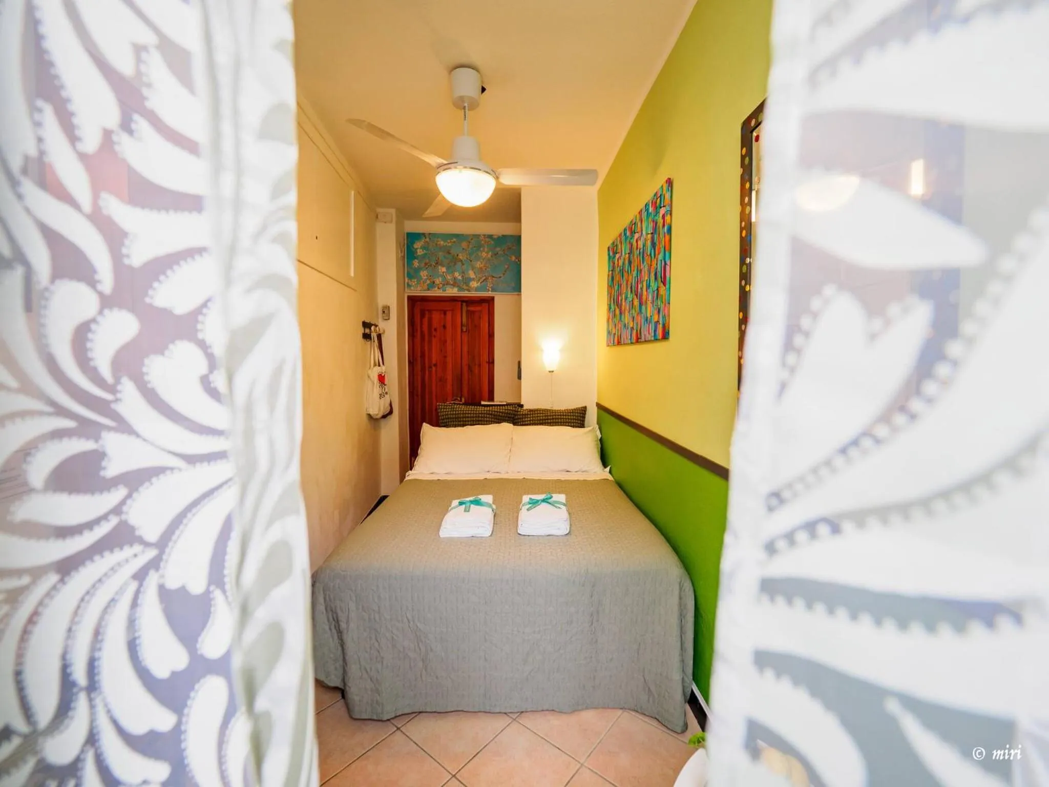 Bed in Carmelina Tiny Village Room