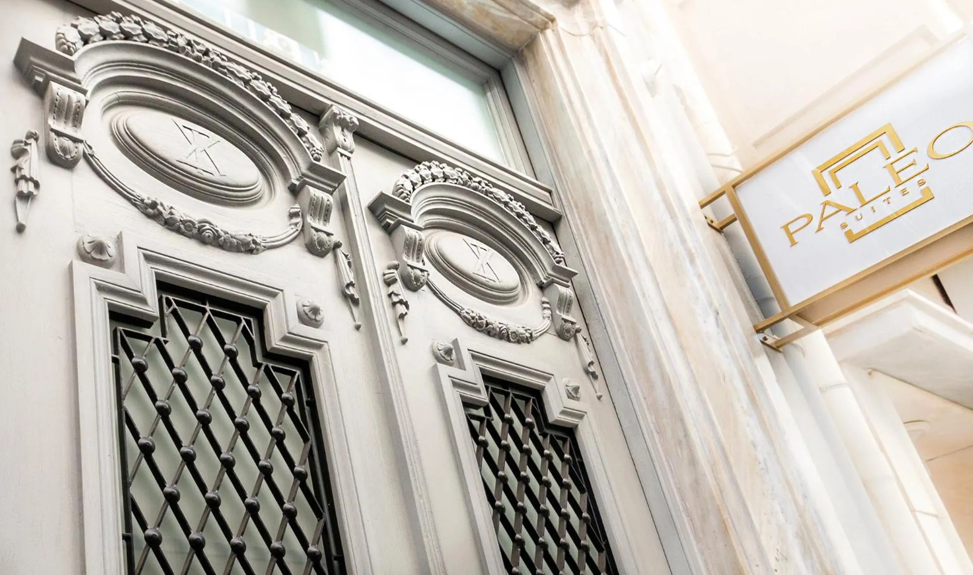 Property logo or sign in Paleo Suites