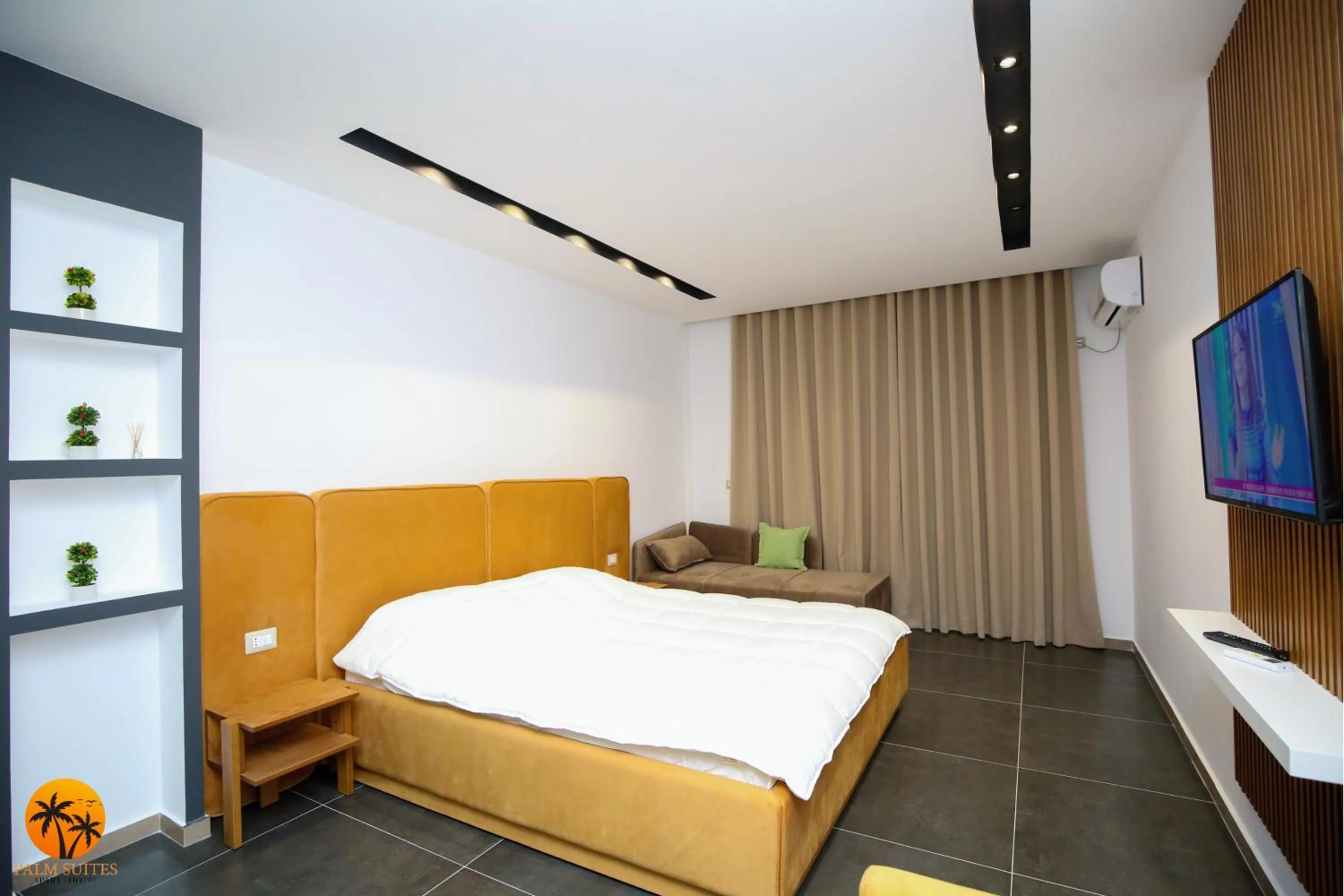 Bed in Palm Suites Apartment-Suite