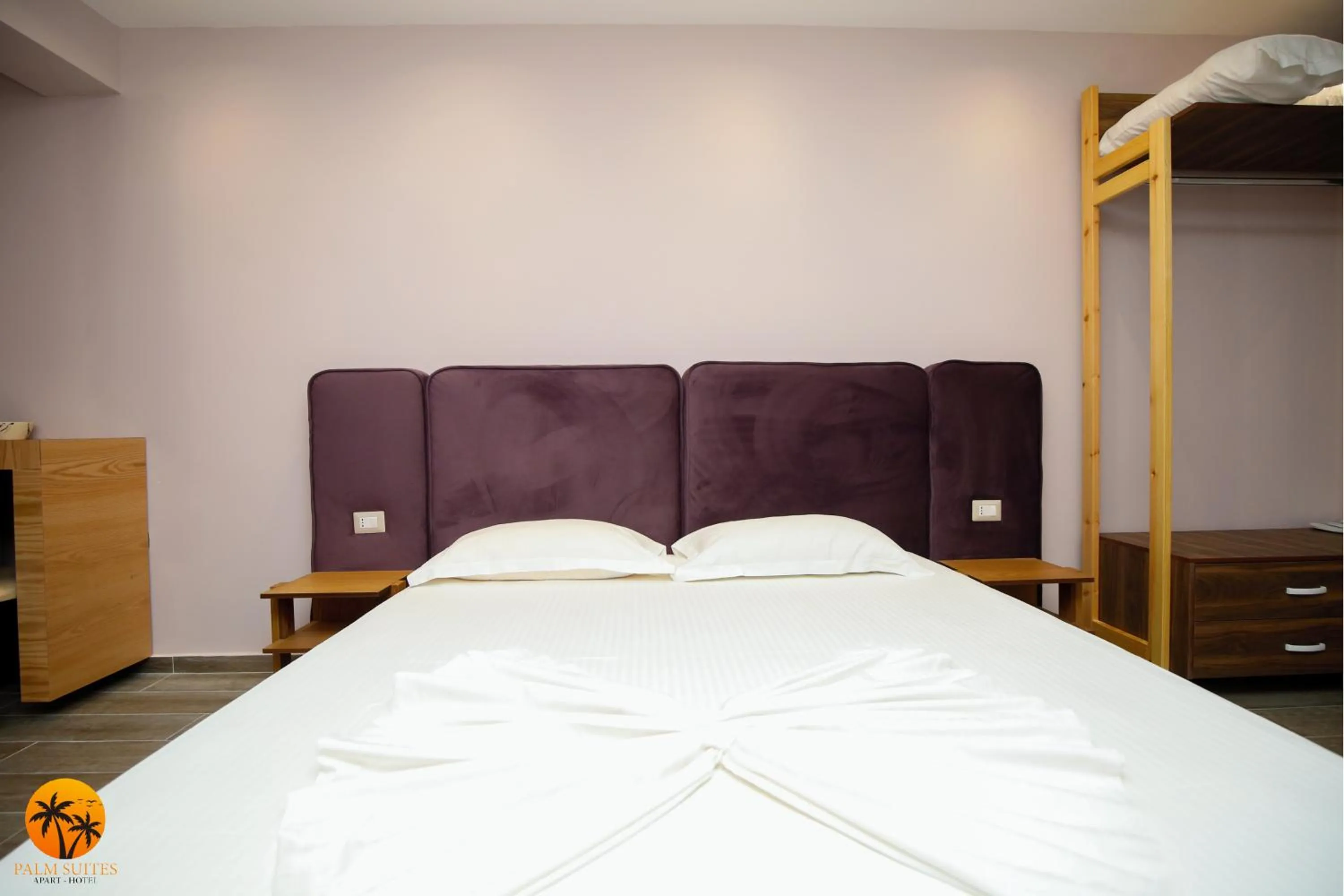 Bed in Palm Suites Apartment-Suite