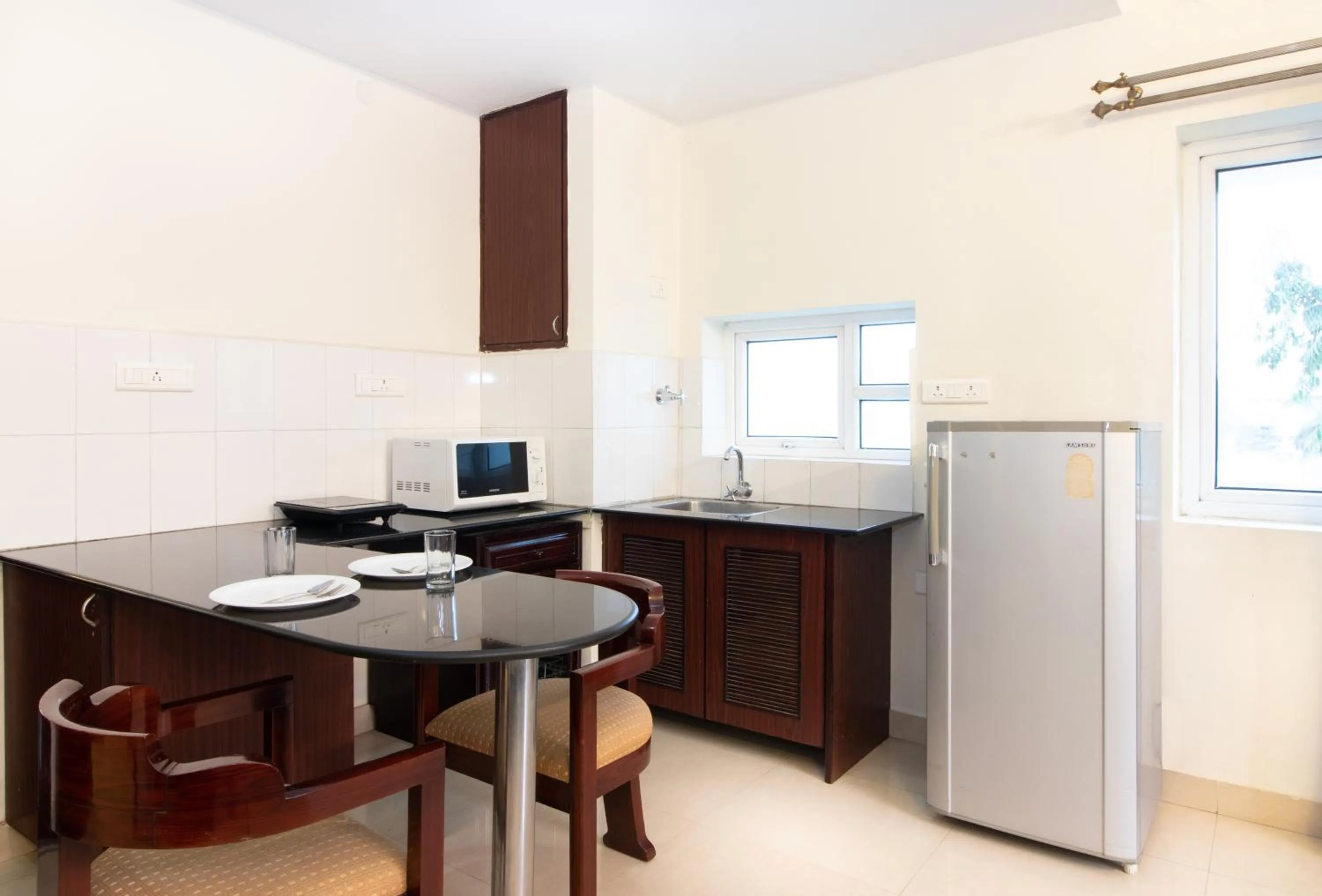 Kitchen or kitchenette in Sanctum Suites Indiranagar Bangalore