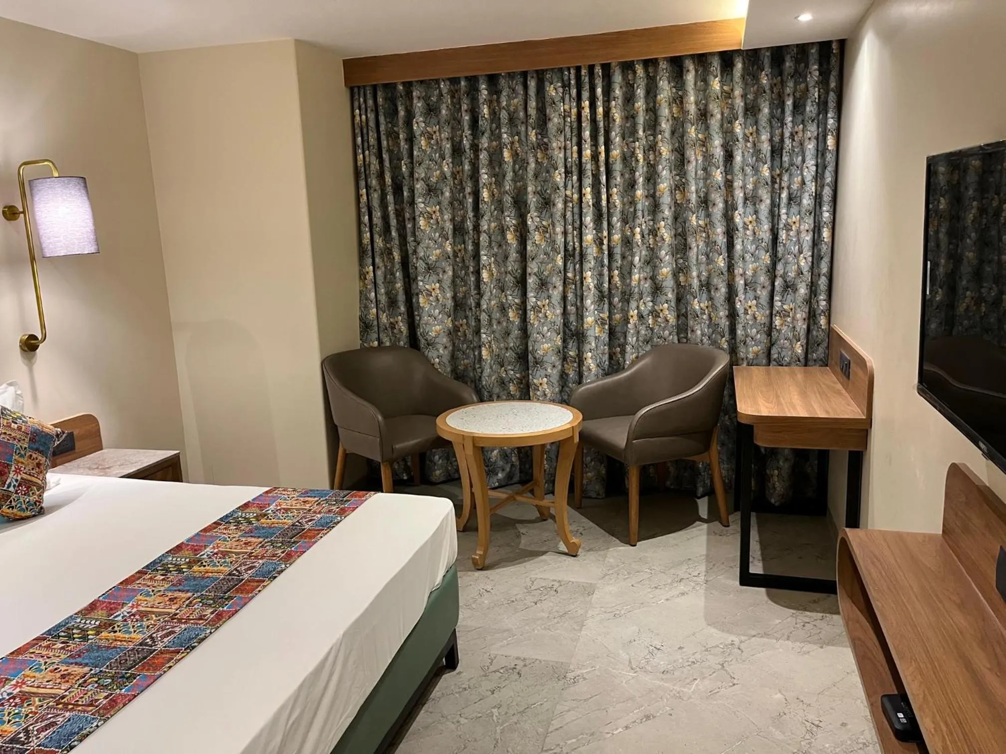 Seating area, Bed in Suvidha Suites
