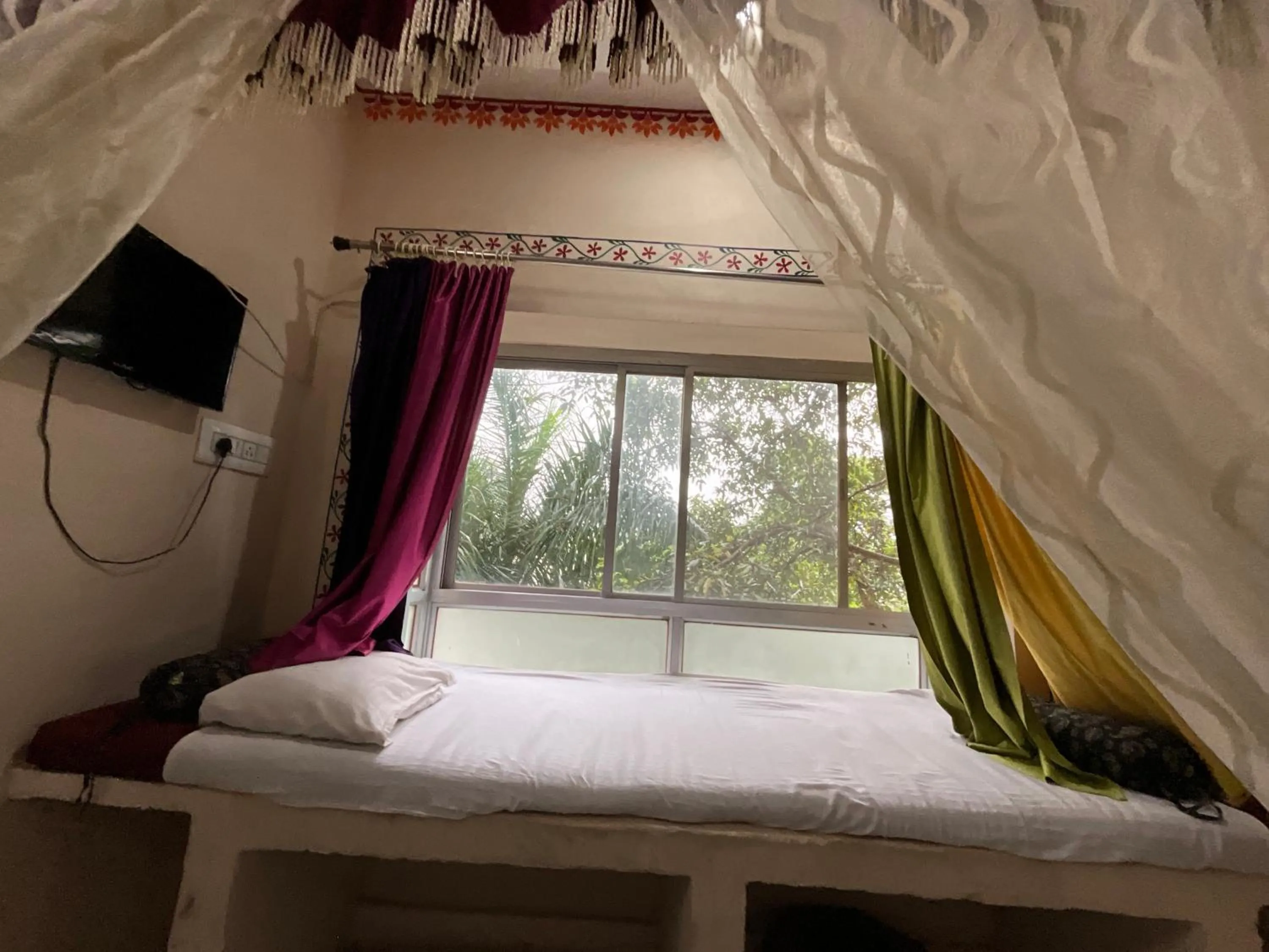 Seating area, Bed in HOTEL HANUMAN GHAT On LAKE PICHOLA