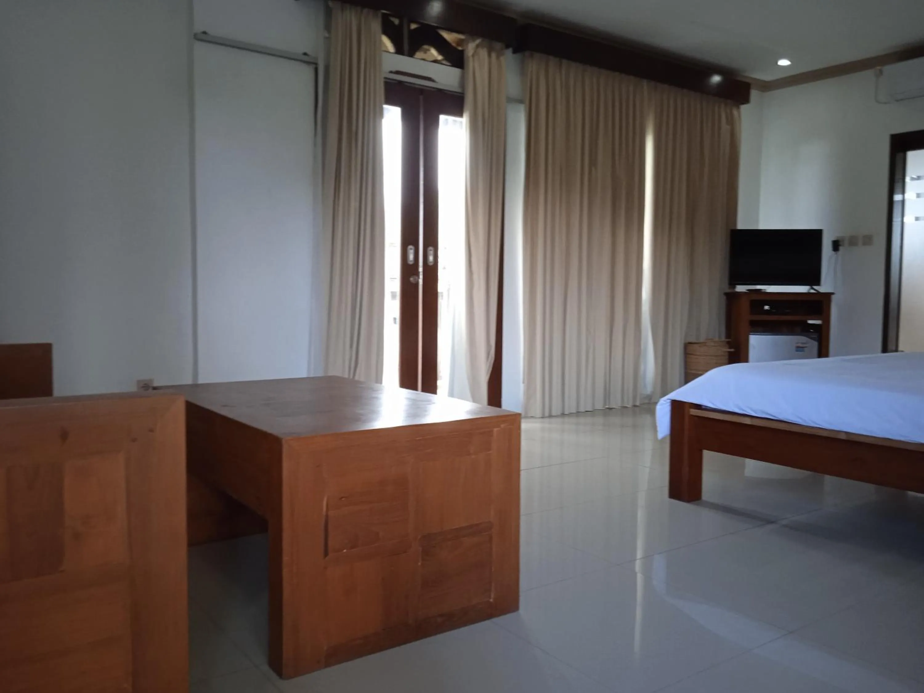 Seating area, Bed in family house hotel kuta