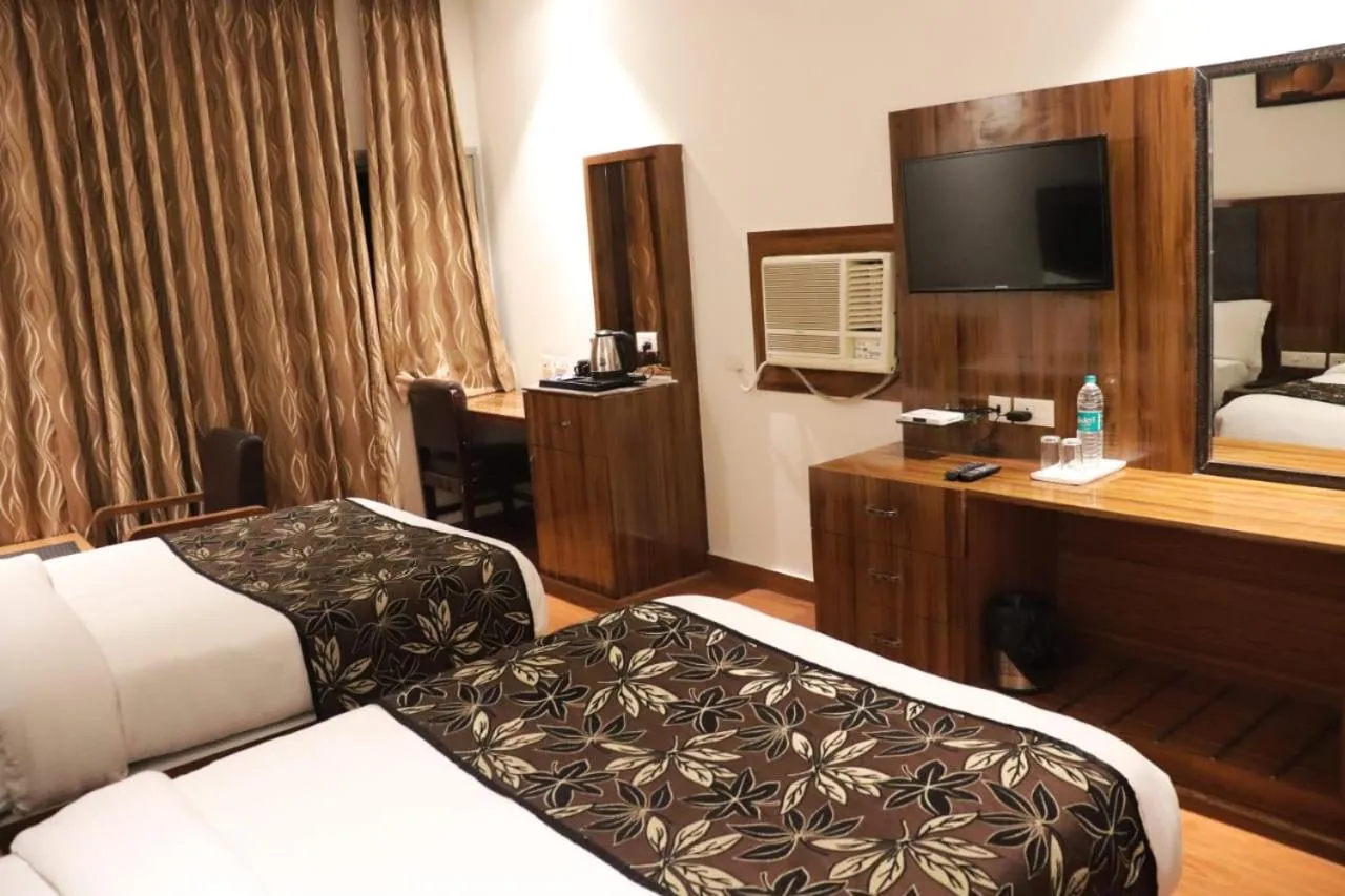 Communal lounge/ TV room, Bed in Grand Geet Hotels