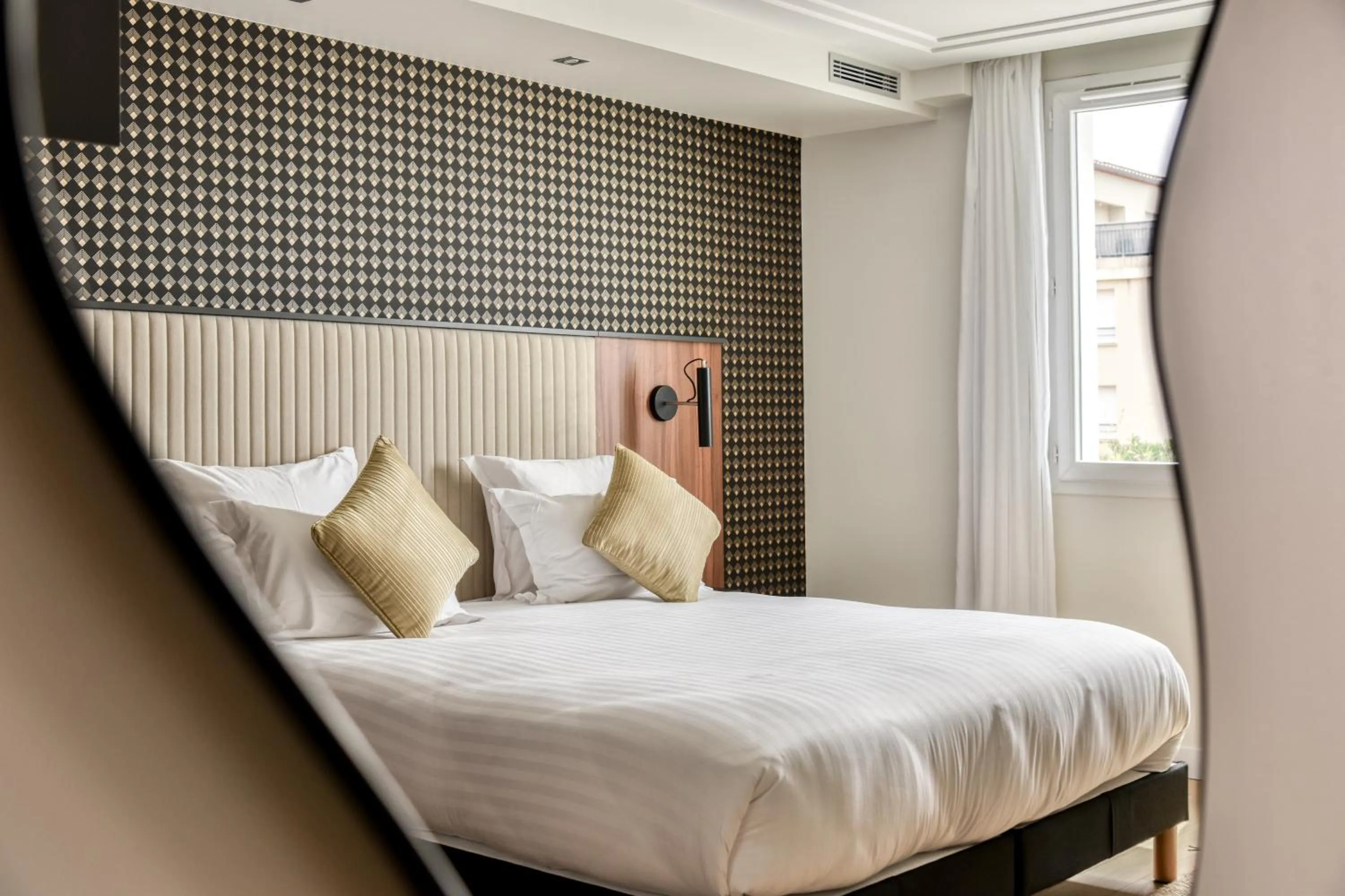 Bed in Zenitude Hotel La Valadière, Ascend Hotel Collection