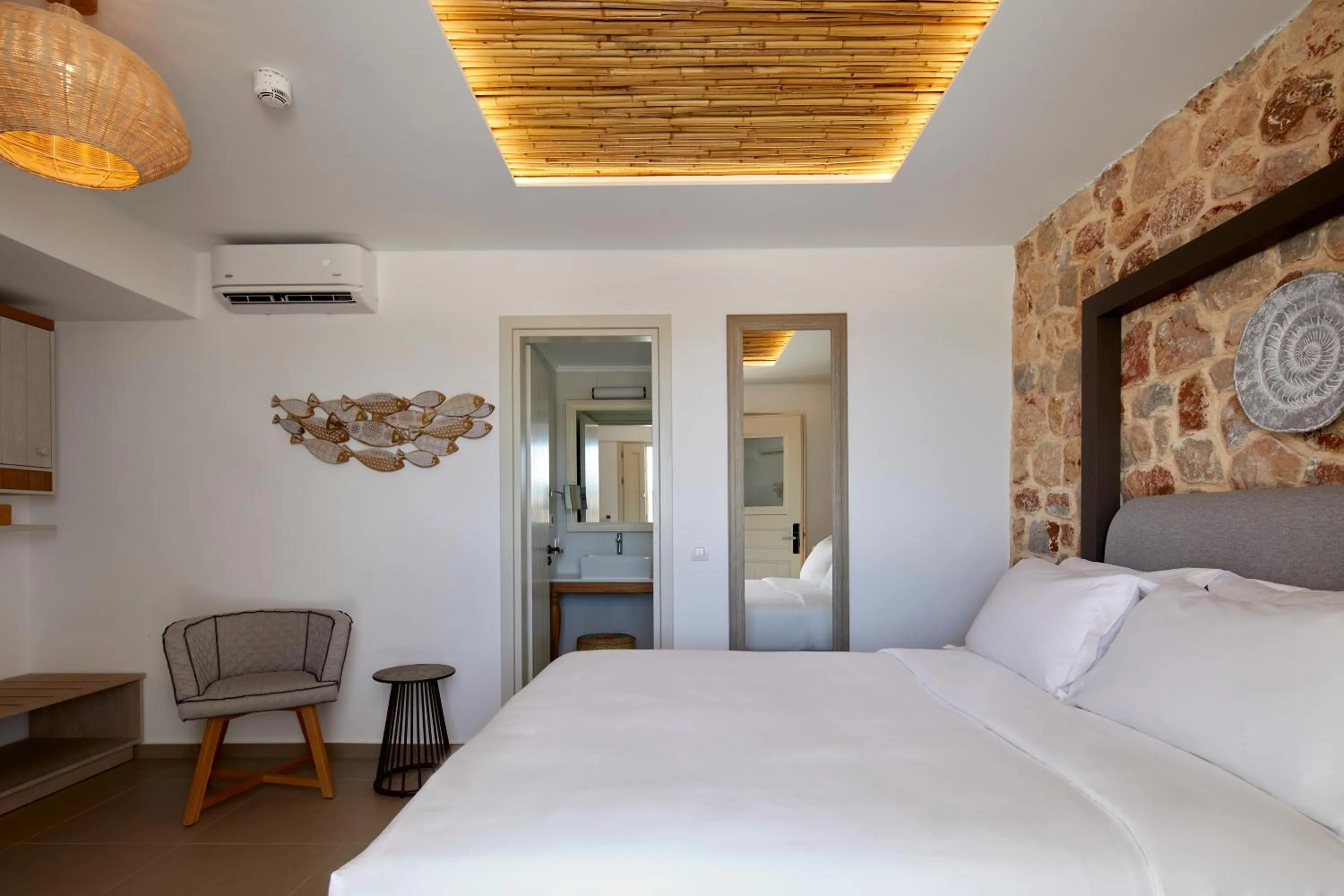 Bed in Sea Breeze Santorini Beach Resort, Curio By Hilton