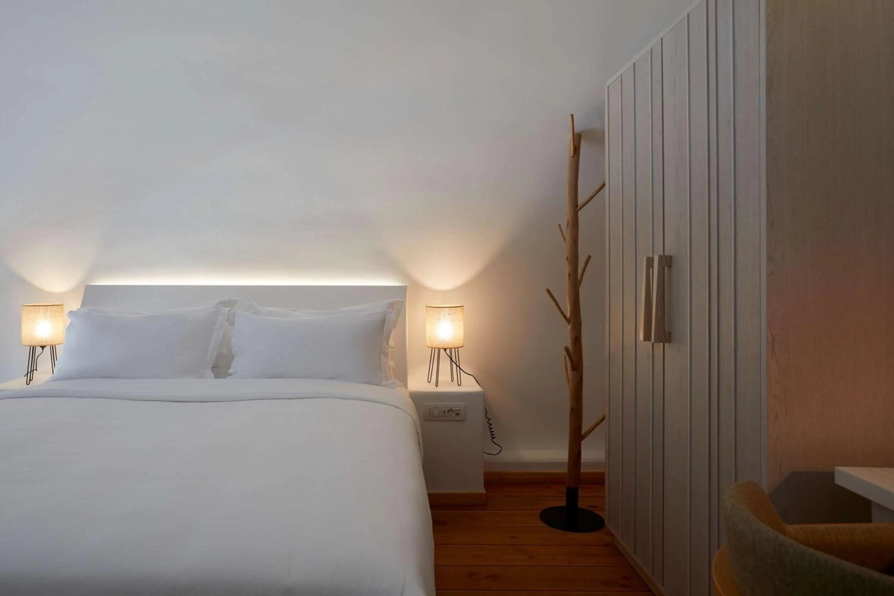 Bed in Sea Breeze Santorini Beach Resort, Curio By Hilton